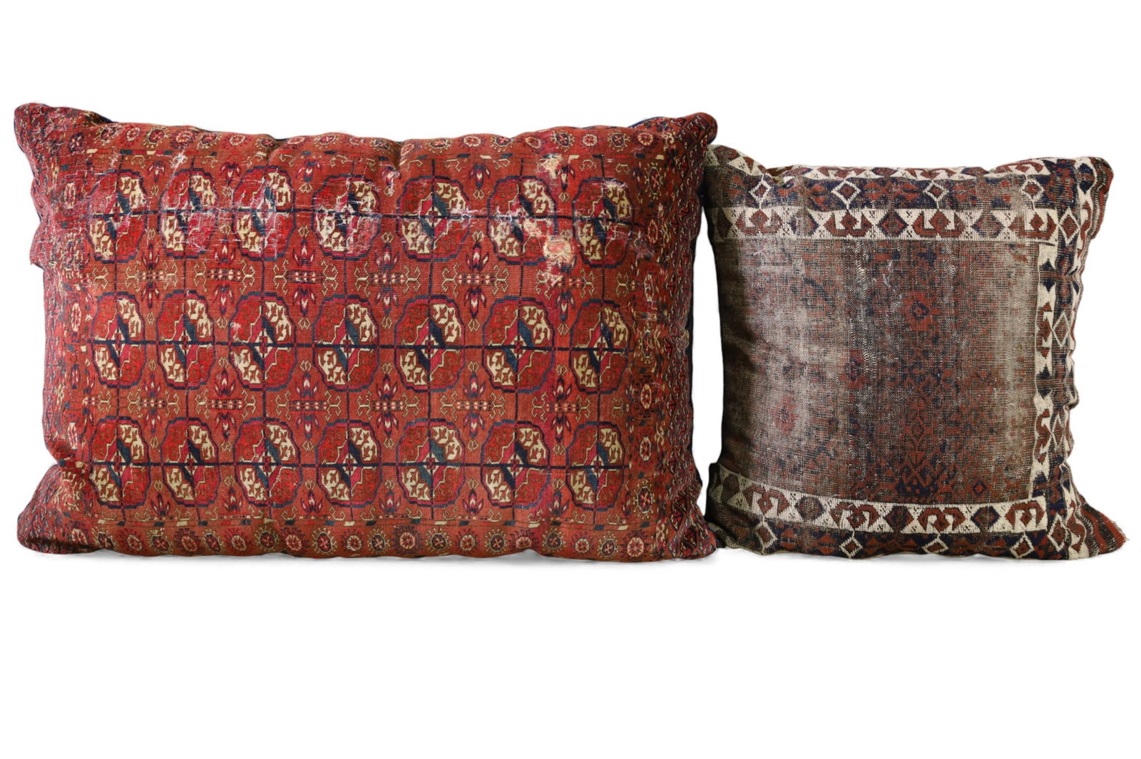 2 RUG PILLOWS: 2 LARGE HANDMADE WOOL RUG PILLOWS. OLD MOTH DAMAGE. LOW PILE. 46" - 28" L.