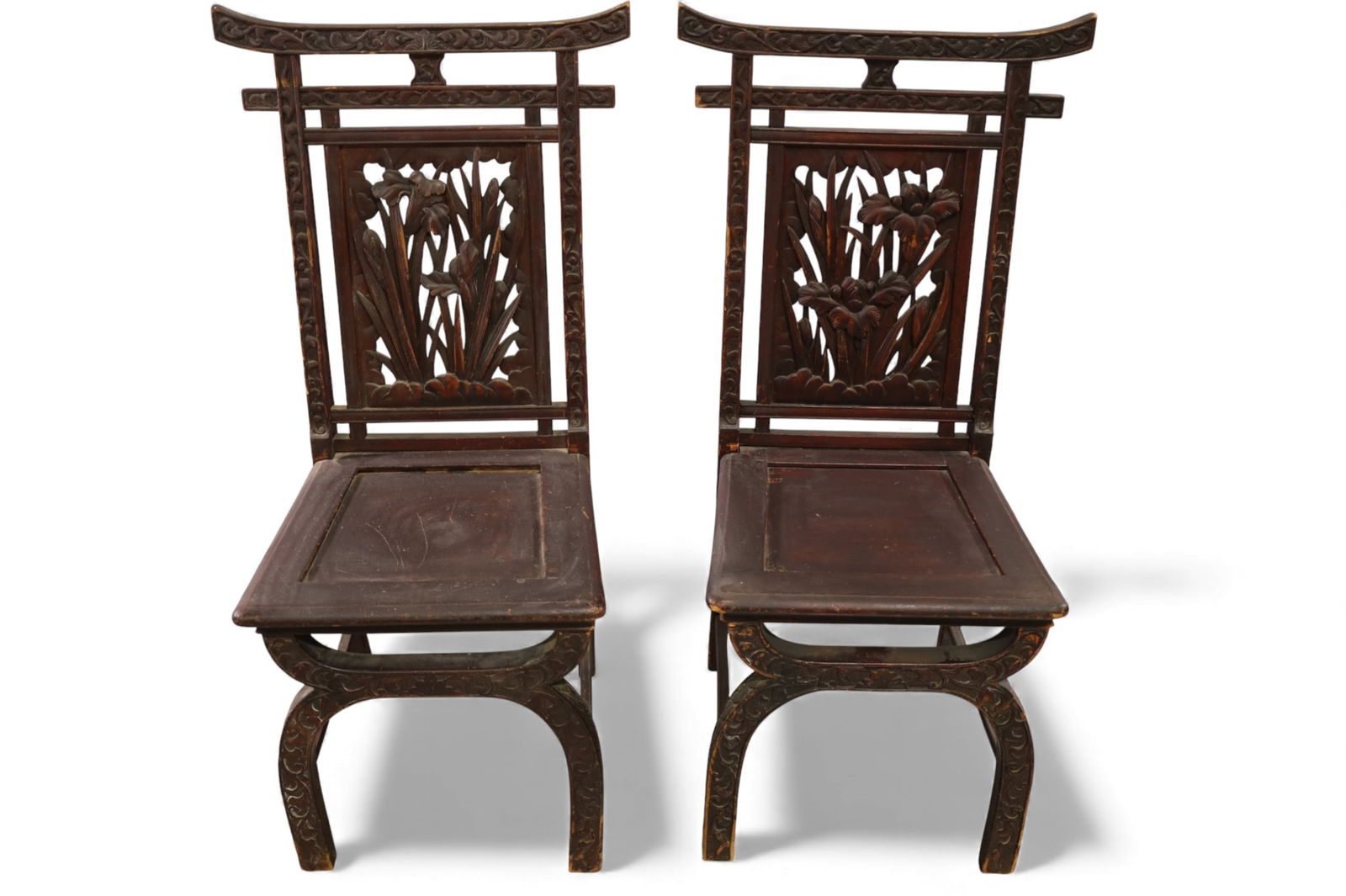 PAIR OF CARVED CHINESE CHAIRS: PAIR OF HIGHLY CARVED CHINESE SIDE CHAIRS, FLORAL CARVED BACKS. WEAR TO FINISH, CHIPS TO CARVING. 21" W x 18" D x 42" H. THIS ITEM EXCEEDS SIZE LIMITATIONS FOR IN HOUSE SHIPPING, MUST BE PICKED UP IN