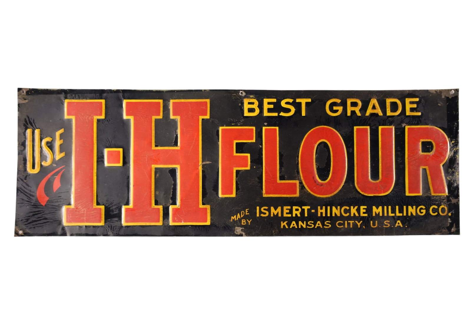 I-H FLOUR TIN SIGN: EMBOSSED SINGLE SIDED I-H FLOUR TIN SIGN. 19 1/2" x 6 1/2" H.