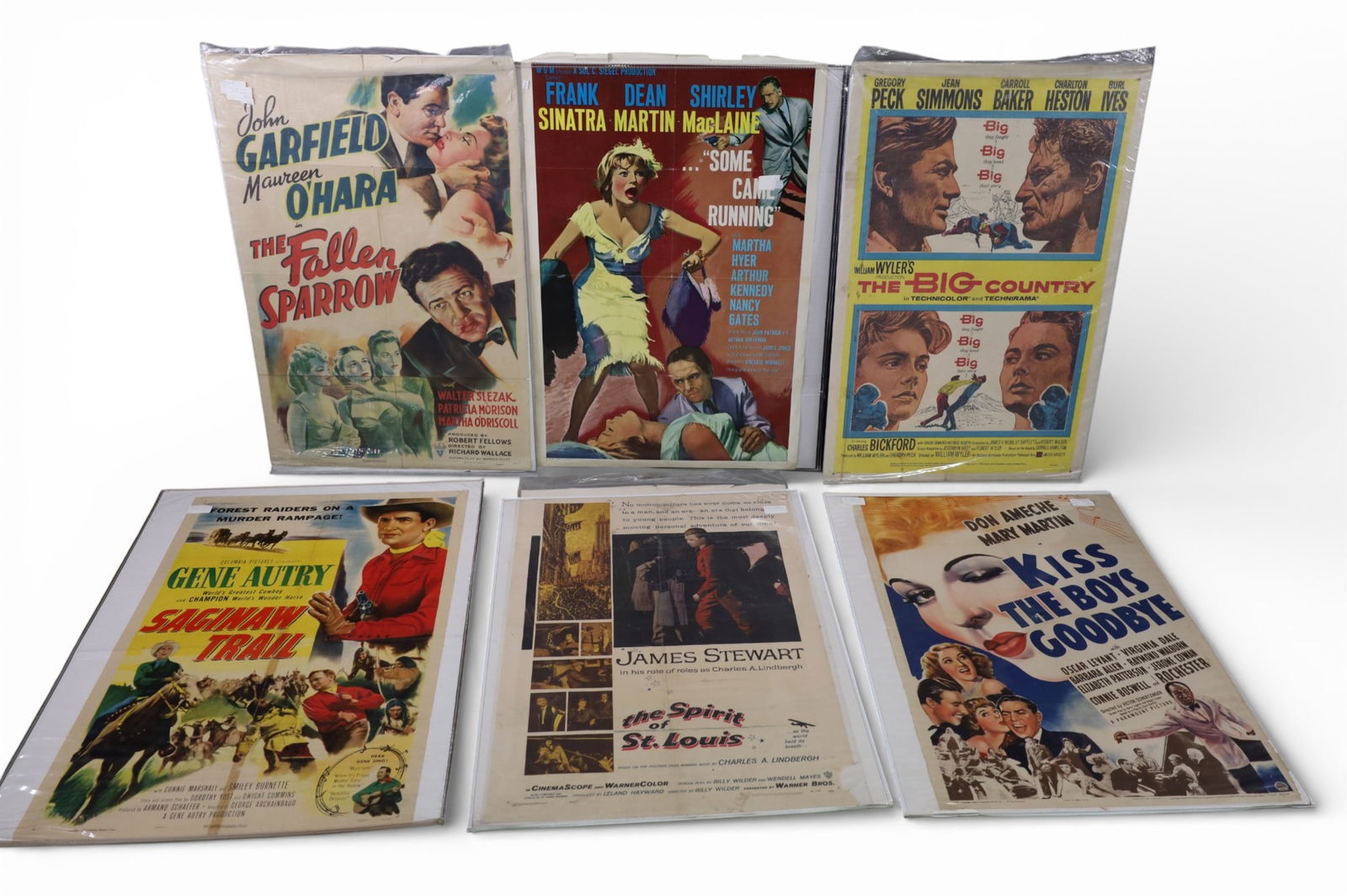 COLLECTION OF VINTAGE MOVIE POSTERS: THE BIG COUNTRY, KISS THE BOYS GOODBYE, SOME CAME RUNNING, THE FALLEN SPARROW, THE SPIRIT OF ST LOUIS, SAGINAW TRAIL. SOME CORNER DAMAGE AND CREASING. 27" x 41"