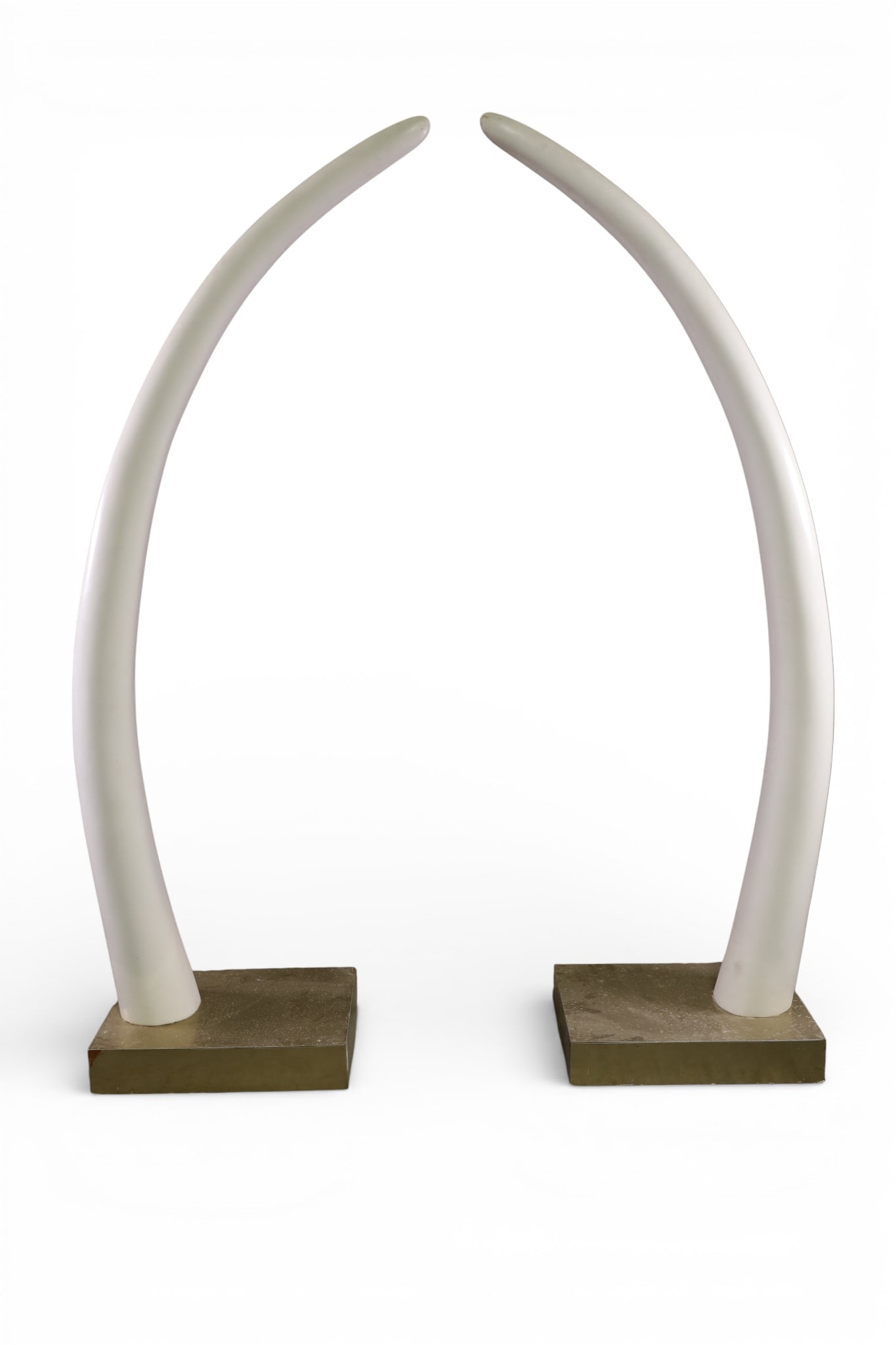 PAIR OF 6 FOOT TALL FAUX TUSKS: ON BRASS BASE, 73" H. THIS ITEM EXCEEDS SIZE LIMITATIONS FOR IN HOUSE SHIPPING, MUST BE PICKED UP IN HOUSE OR SHIPPED VIA 3rd PARTY GROUND SHIPPER.