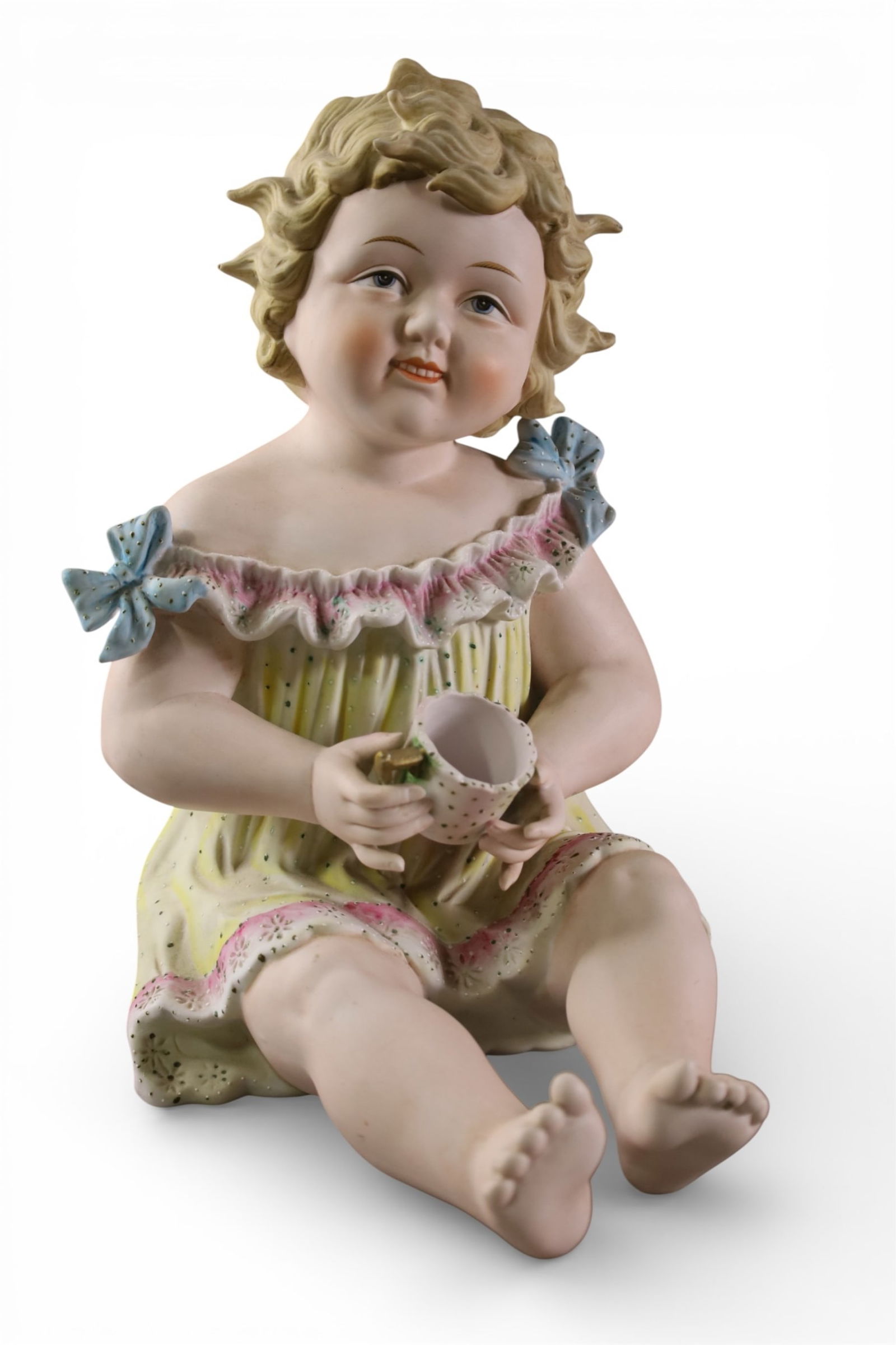BISQUE PIANO BABY: BISQUE PIANO BABY FIGURE, SEATED BABY. 12 1/2" H.