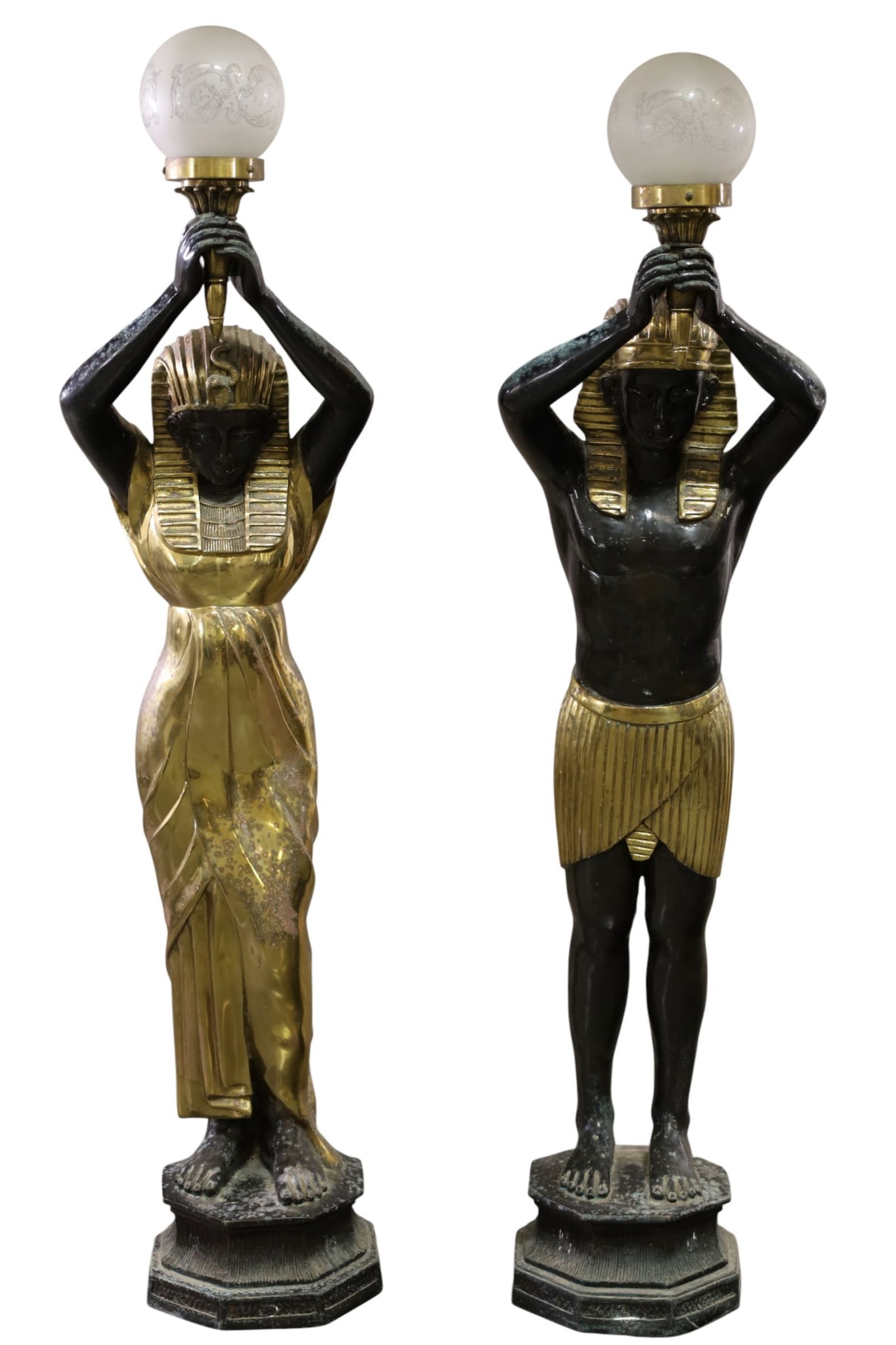 PAIR OF EGYPTIAN REVIVAL FLOOR LAMPS: CAST METAL EGYPTIAN FLOOR LAMPS, CORROSION AND DISCOLORED METAL SURFACE. WITH ETCHED BALL SHADES. 57" H. THIS ITEM EXCEEDS SIZE LIMITATIONS FOR IN HOUSE SHIPPING, MUST BE PICKED UP IN HOUSE OR 