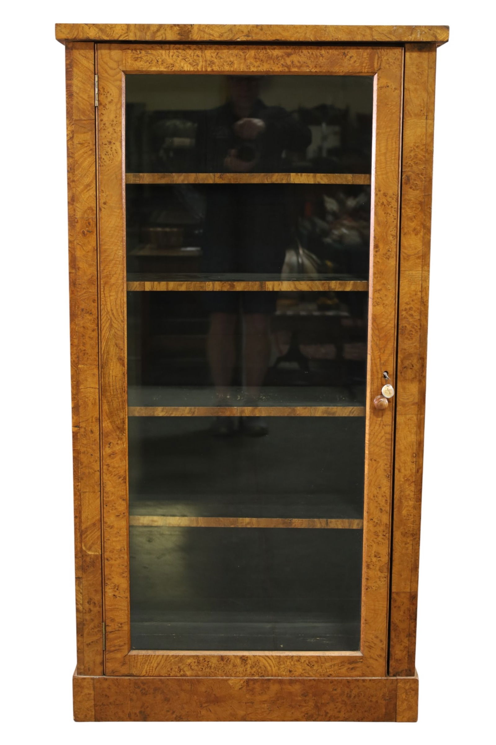 19TH CENTURY SINGLE DOOR BOOKCASE: BURLED SINGLE DOOR BOOKCASE, GLASS DOOR, WITH KEY. 32" W x 13" D x 61" H. THIS ITEM EXCEEDS SIZE LIMITATIONS FOR IN HOUSE SHIPPING, MUST BE PICKED UP IN HOUSE OR SHIPPED VIA 3rd PARTY GROUND 