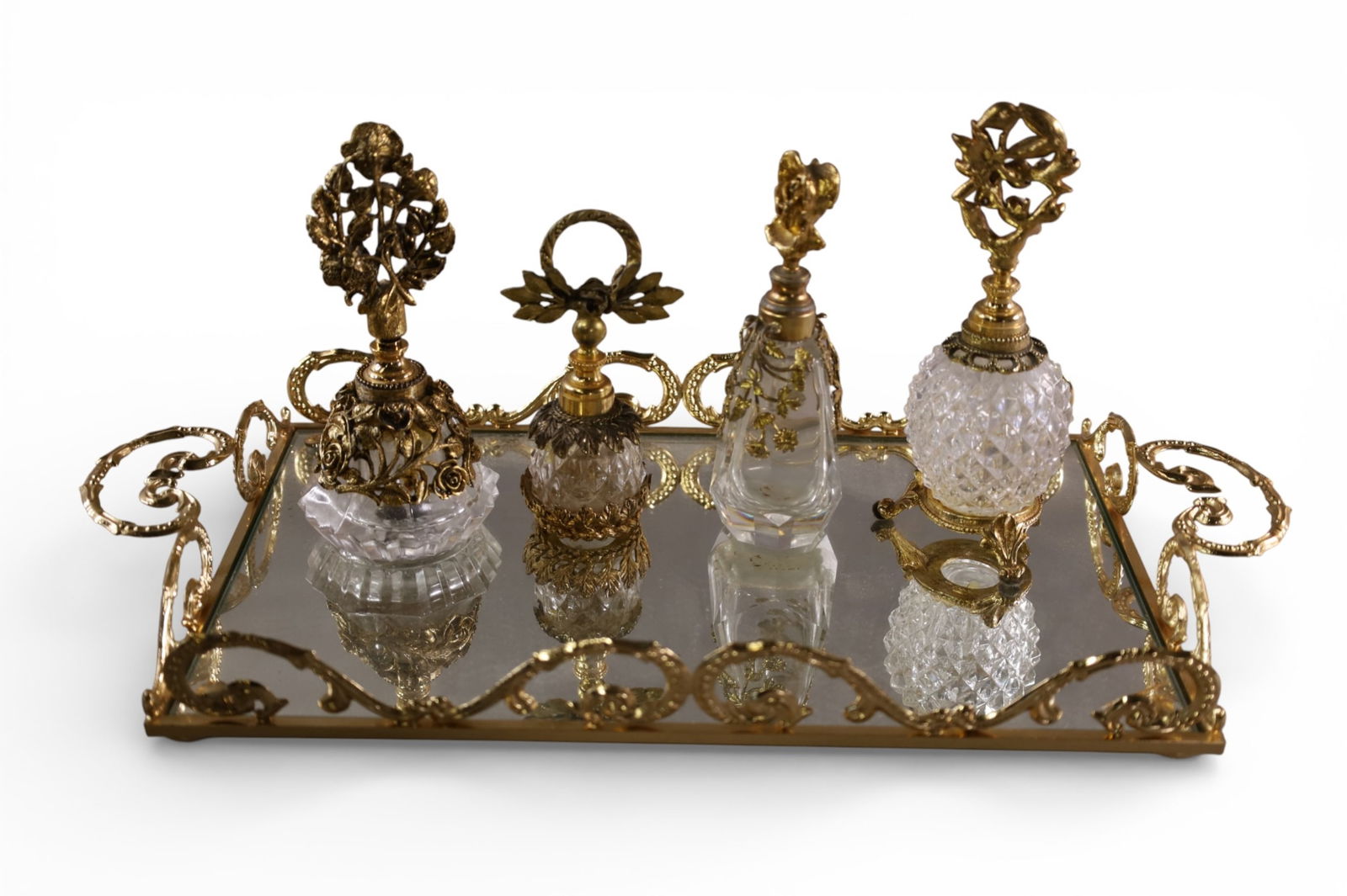 5 PIECE VANITY SET: MIRRORED TRAY & 4 PERFUMES. 5" - 7" H PERFUMES. 17" W TRAY.