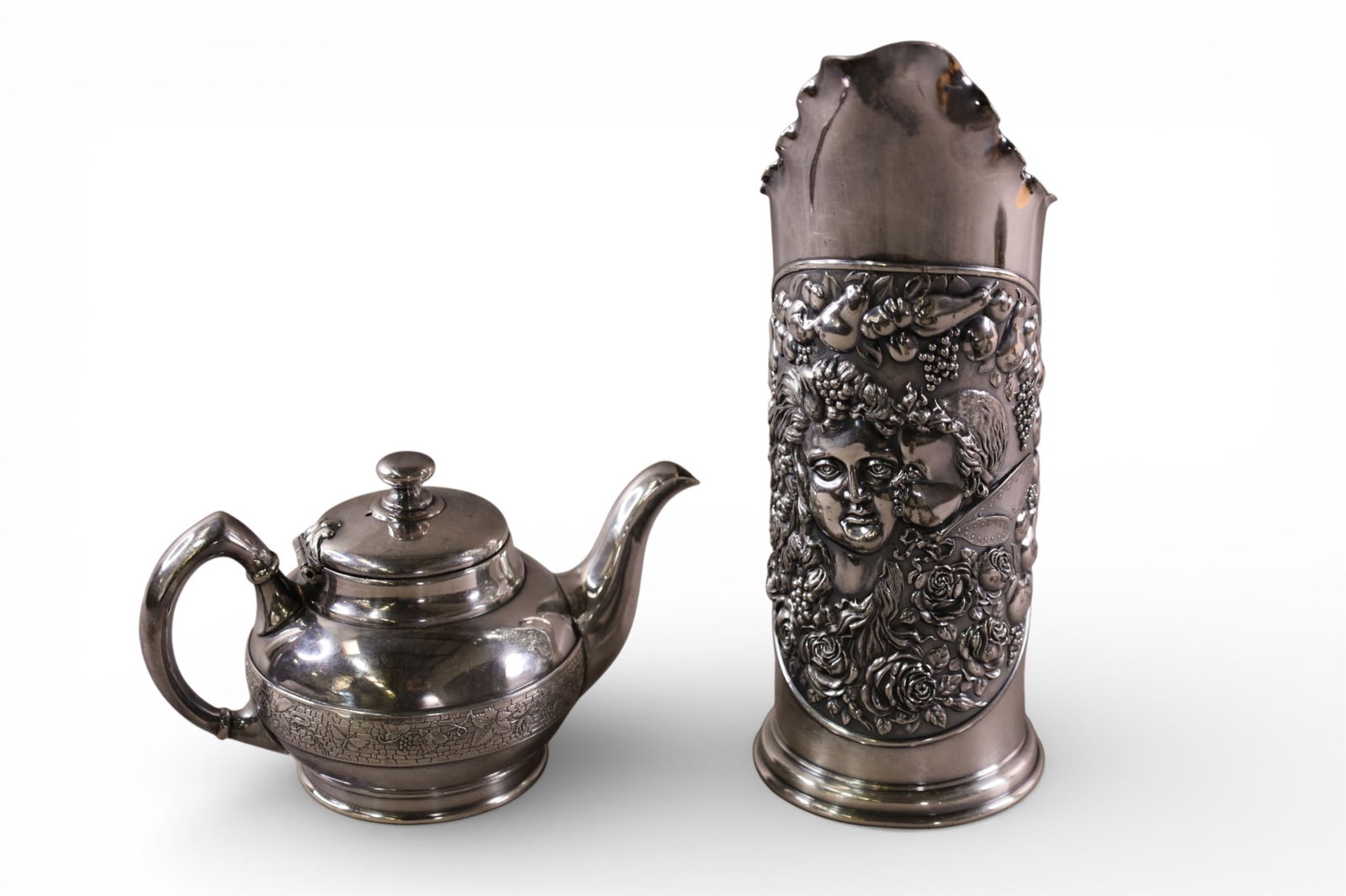 2 PIECES OF VICTORIAN SILVERPLATE: SILVERPLATED PITCHER WITH CHERUB DECORATION BY TUFTS, & REED AND BARTON TEA POT. 3 1/2" - 9 1/2" H.