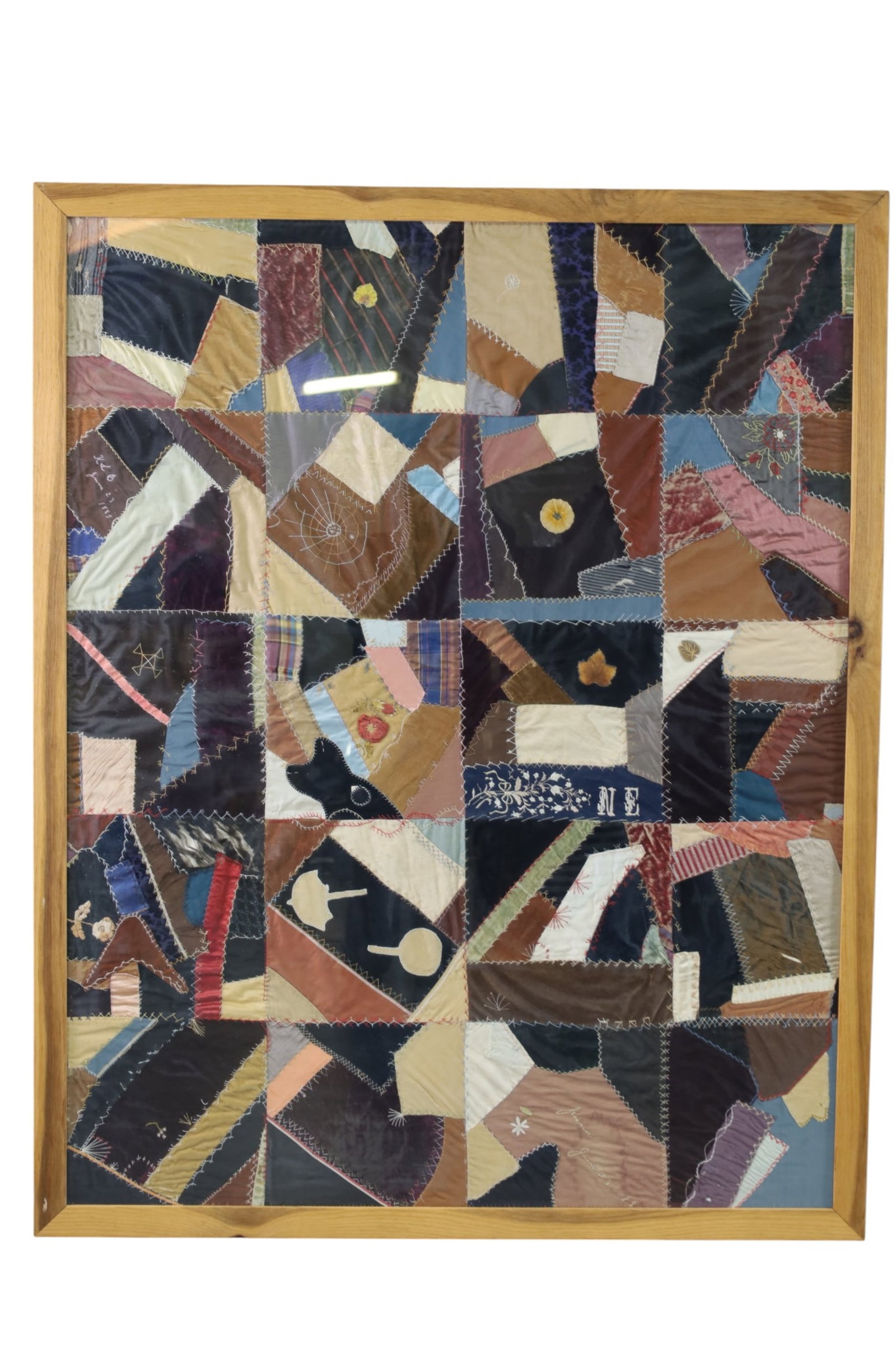 LARGE ANTIQUE FRAMED QUILT: LARGE FRAMED CRAZY QUILT, 51 1/2" W x 64 1/2" H. THIS ITEM EXCEEDS SIZE LIMITATIONS FOR IN HOUSE SHIPPING, MUST BE PICKED UP IN HOUSE OR SHIPPED VIA 3rd PARTY GROUND SHIPPER.