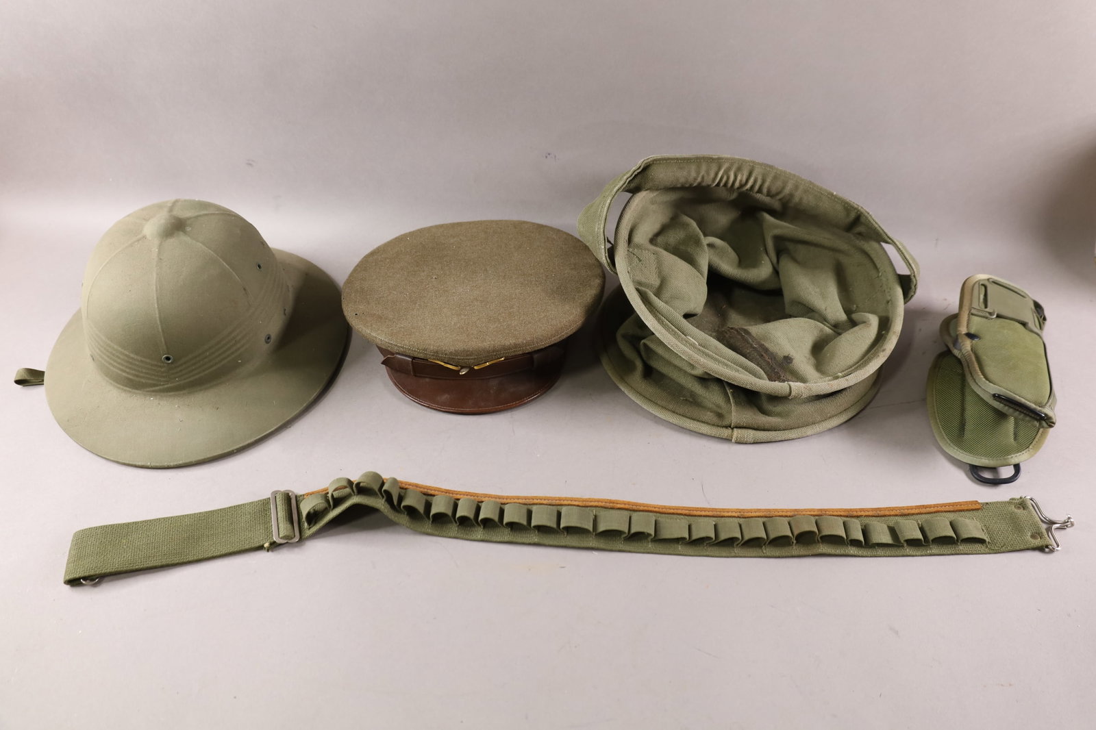 MISC U.S. MILITARY ITEMS: WWII AIR FORCE CADET HAT, WATER BUCKET, HOLSTER AND BELT, PITH HELMET.