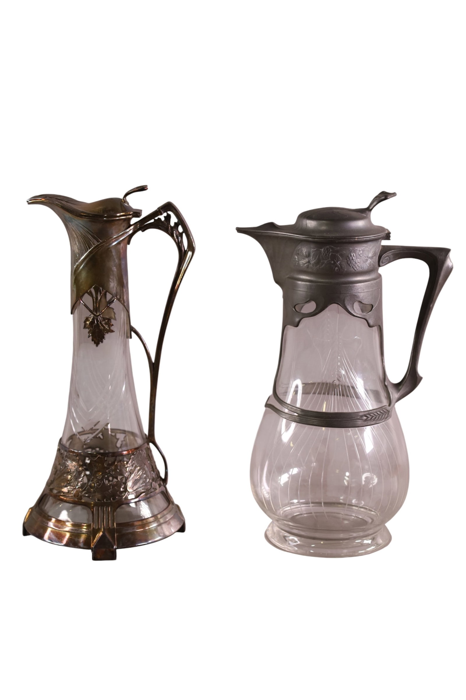 2 CRYSTAL AND PEWTER EWERS: LEAF FORM DECORATED EWERS IN PEWTER HOLDERS. 14" H.