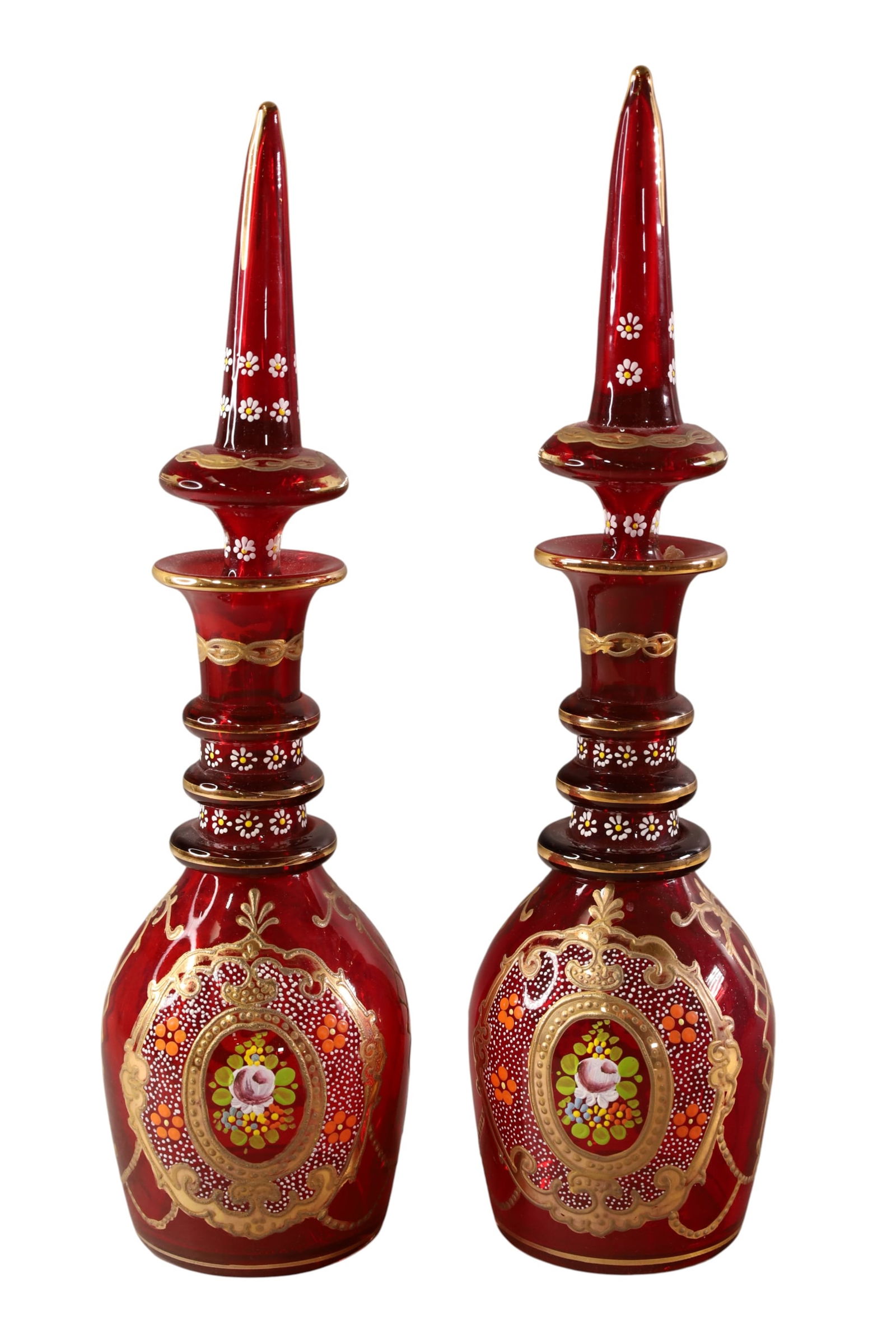 PAIR OF RUBY GLASS BOHEMIAN DECANTERS: FLORAL ENAMEL DECORATED BOHEMIAN RUBY DECANTERS. 16" H.