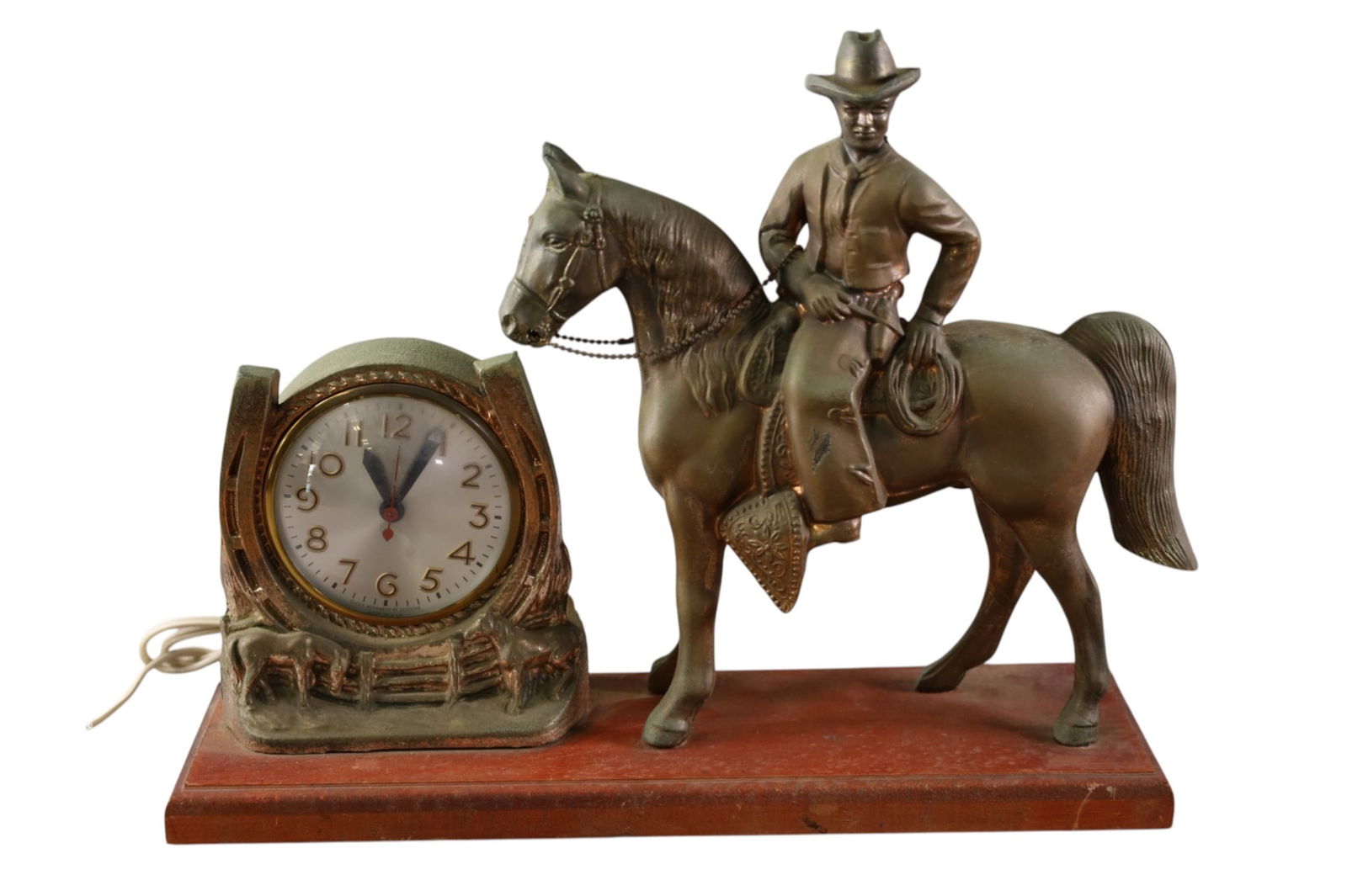 VINTAGE COWBOY ON HORSE CLOCK: COWBOY ON HORSE FORM MANTLE CLOCK, ON WOODEN BASE. NEEDS NEW PLUG. 16" W x 13" H.