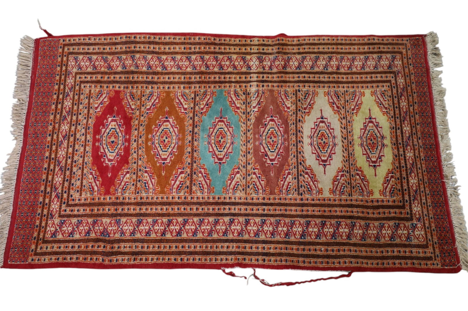 APPROX 5' 4" x 3' 1" HANDMADE WOOL RUG: HANDMADE WOOL RUG. WEAR TO EDGE.