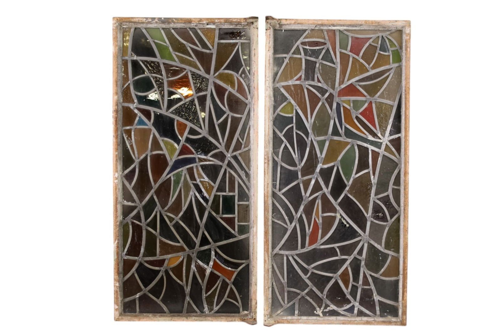 PAIR OF LEADED WINDOWS: PAIR OF LARGE LEADED GLASS WINDOWS IN METAL FRAMES, CRACKED PANELS. 23" W x 49" L. THIS ITEM EXCEEDS SIZE LIMITATIONS FOR IN HOUSE SHIPPING, MUST BE PICKED UP IN HOUSE OR SHIPPED VIA 3rd PARTY GROUND