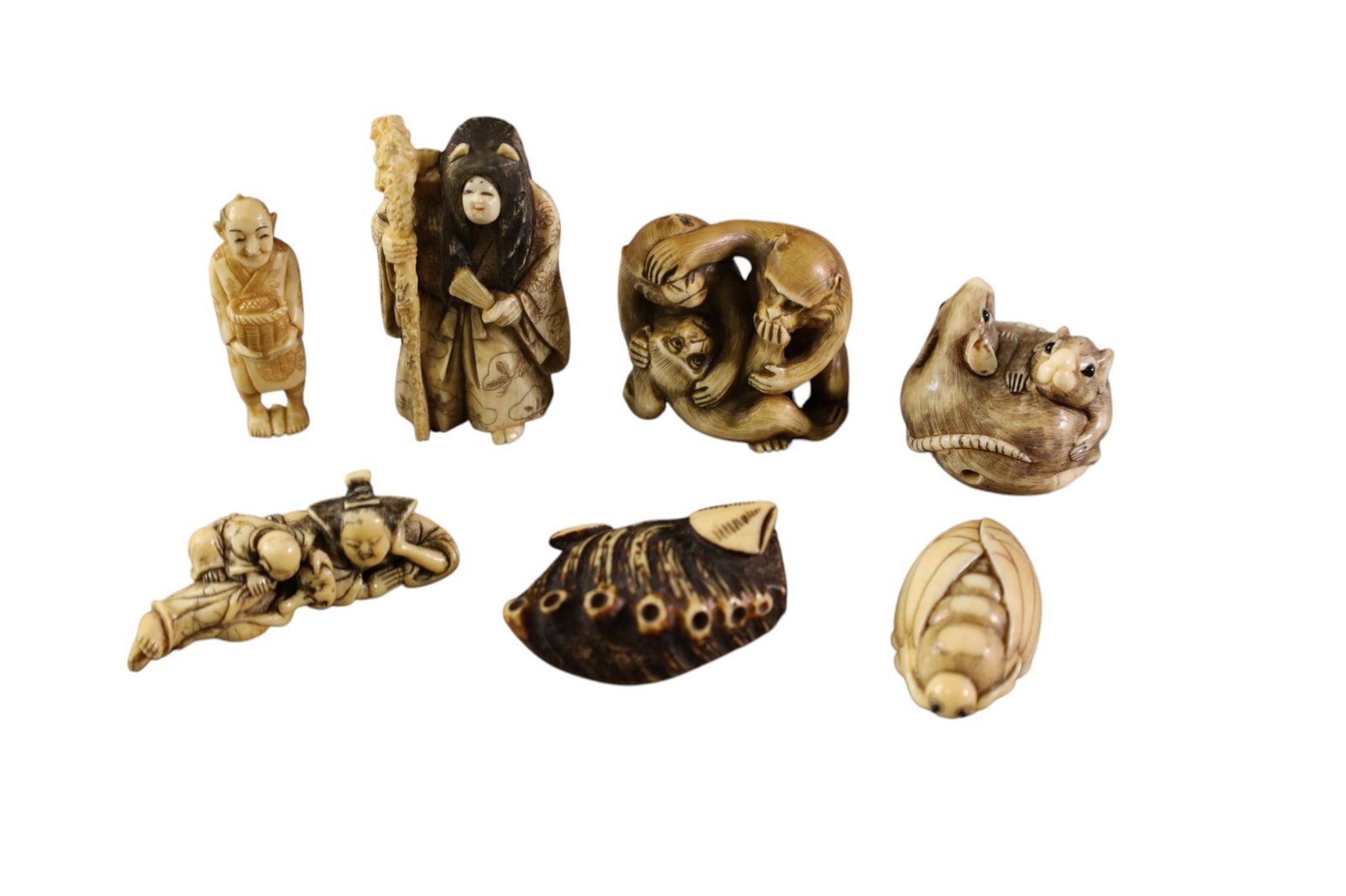 GROUPING OF NETSUKES: 7 NETSUKES, MICE, MONKEYS, WISE MEN, AND MORE. 2 - 2 1/2"