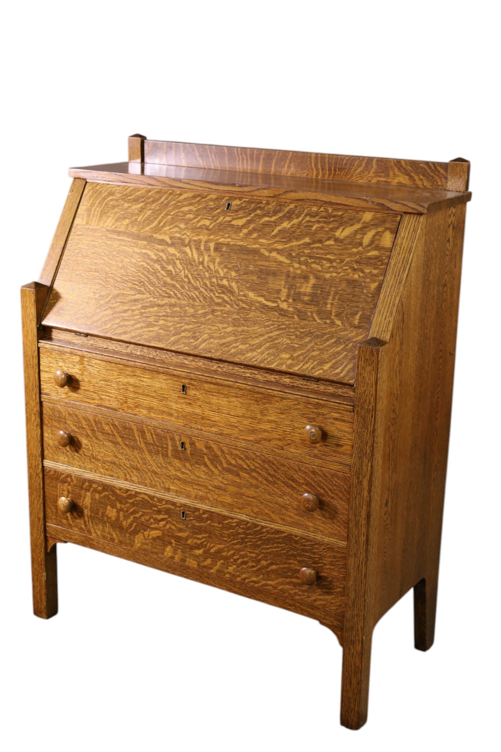 MISSION OAK DROP FRONT DESK: MISSION OAK DROP FRONT DESK, THREE LOWER DRAWERS. DROP FRONT WITH INTERIOR. WITH KEY. 34 1/2" W x 16" D x 34" H. THIS ITEM EXCEEDS SIZE LIMITATIONS FOR IN HOUSE SHIPPING, MUST BE PICKED UP IN HOUSE OR