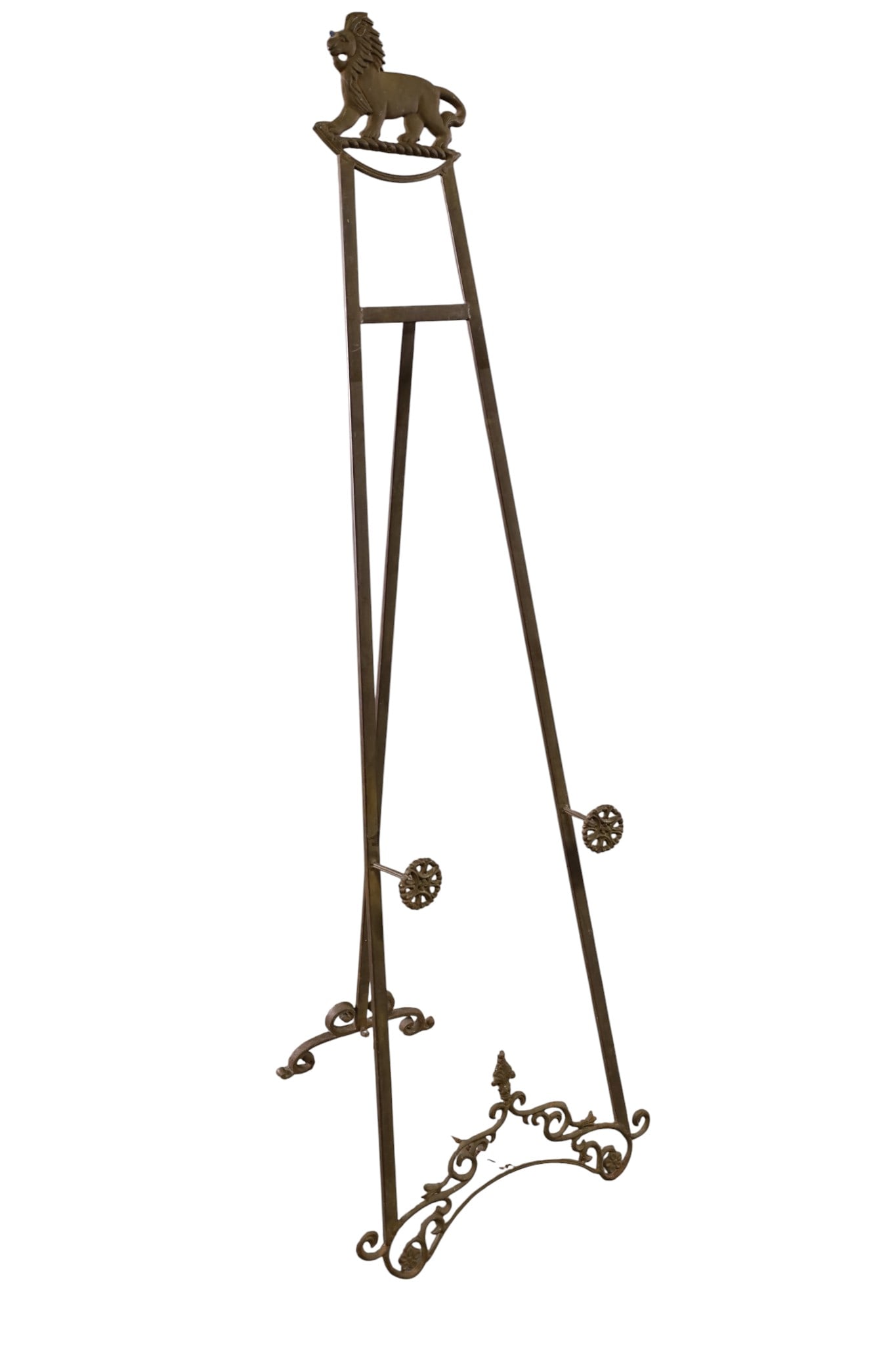 METAL EASEL: DECECORATIVE METAL EASEL, LION DECORATED TOP. 62" H. THIS ITEM EXCEEDS SIZE LIMITATIONS FOR IN HOUSE SHIPPING, MUST BE PICKED UP IN HOUSE OR SHIPPED VIA 3rd PARTY GROUND SHIPPER.