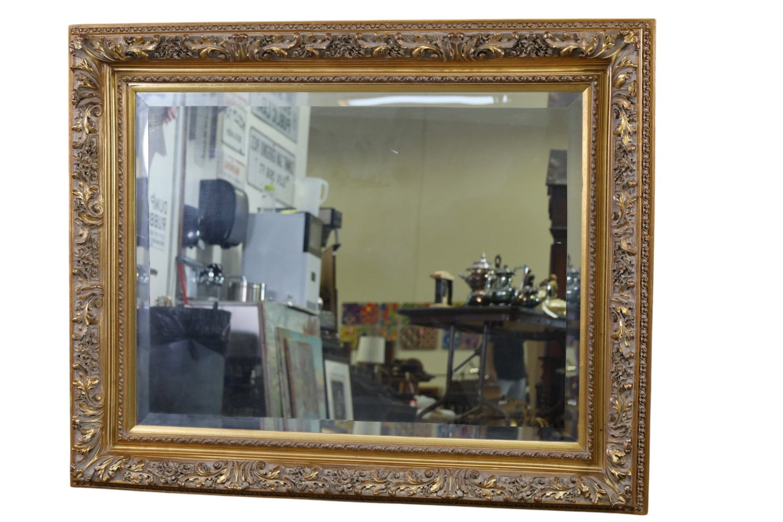 LARGE GILT WALL MIRROR: LARGE GILT WALL MIRROR, BEVELED. 51 1/2" x 42" THIS ITEM EXCEEDS SIZE LIMITATIONS FOR IN HOUSE SHIPPING, MUST BE PICKED UP IN HOUSE OR SHIPPED VIA 3rd PARTY GROUND SHIPPER.