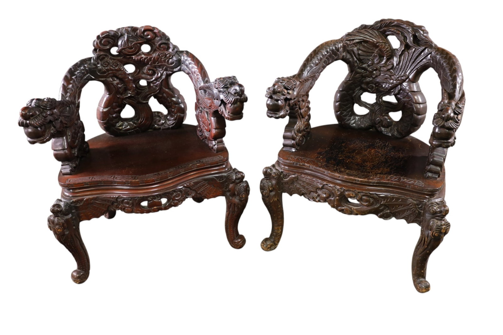 PAIR OF ANTIQUE JAPANESE ARMCHAIRS: PAIR OF HIGHLY CARVED JAPANESE ARMCHAIRS, DRAGON FORM ARMS, SCRATCHES TO SEATS. REPAIRS THROUGHOUT. 25" W x 22" D x 34" H. THIS ITEM EXCEEDS SIZE LIMITATIONS FOR IN HOUSE SHIPPING, MUST BE PICKED UP