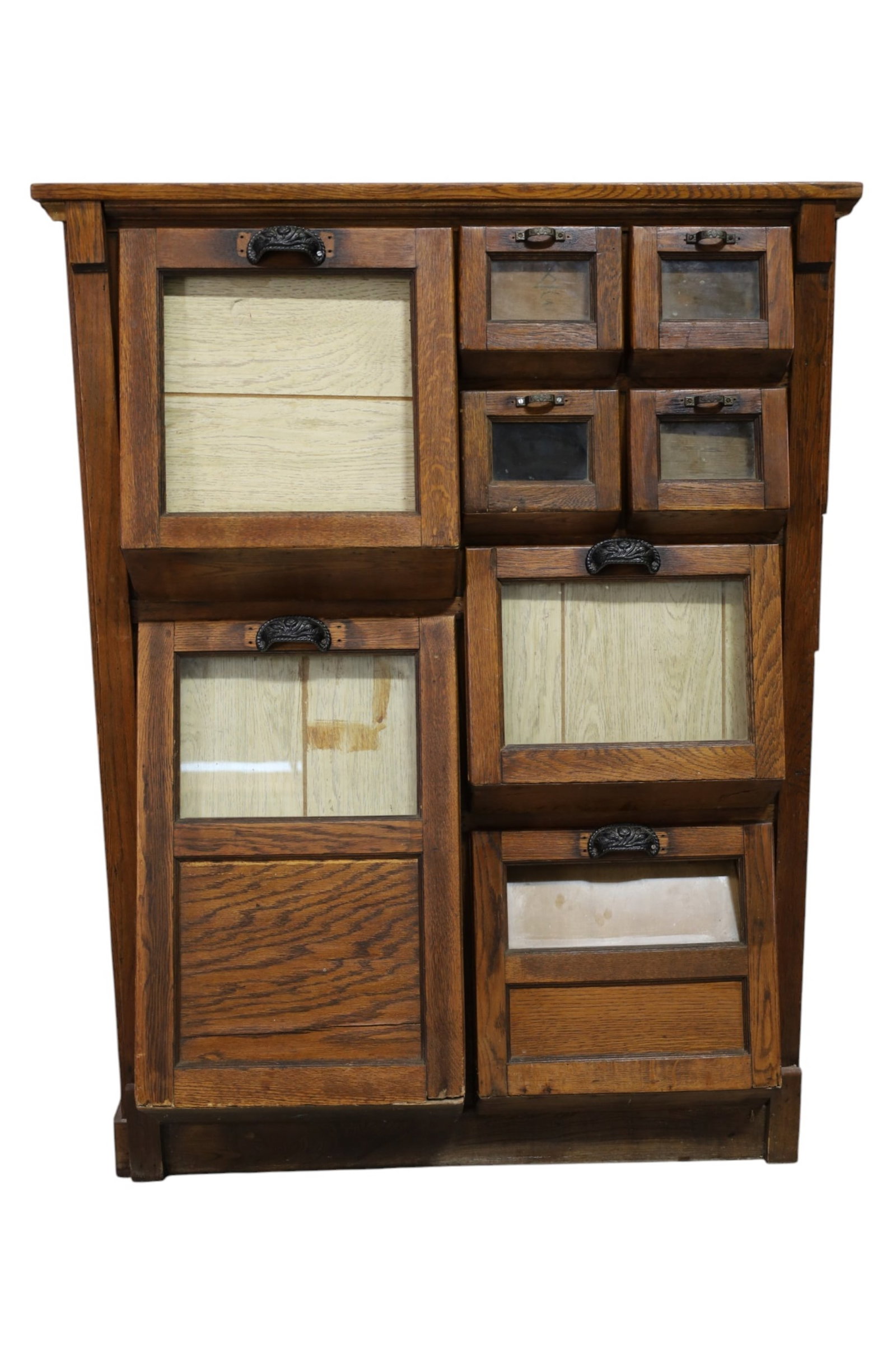 AMERICAN OAK BEAN CABINET: AMERICAN OAK COUNTRY STORE BEAN COUNTER / CABINET. HARDWARE HAS BEEN REPLACED. UNFINISHED SIDE. 42" W x 25" D x 55" H. THIS ITEM EXCEEDS SIZE LIMITATIONS FOR IN HOUSE SHIPPING, MUST BE PICKED UP IN