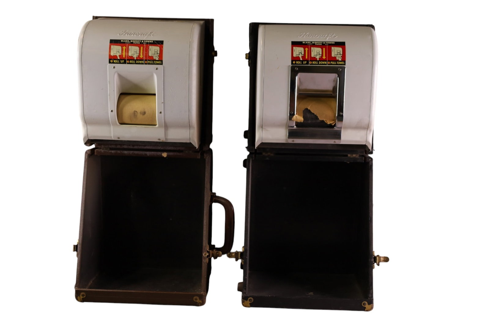 2 SALESMAN SAMPLE TOWEL DISPENSERS: HANDCRAFT TOWEL DISPENSERS IN ORIGINAL CARRYING CASES. MISSING ONE HANDLE. 13" W x 15" H. THIS ITEM EXCEEDS SIZE LIMITATIONS FOR IN HOUSE SHIPPING, MUST BE PICKED UP IN HOUSE OR SHIPPED VIA 3rd PARTY