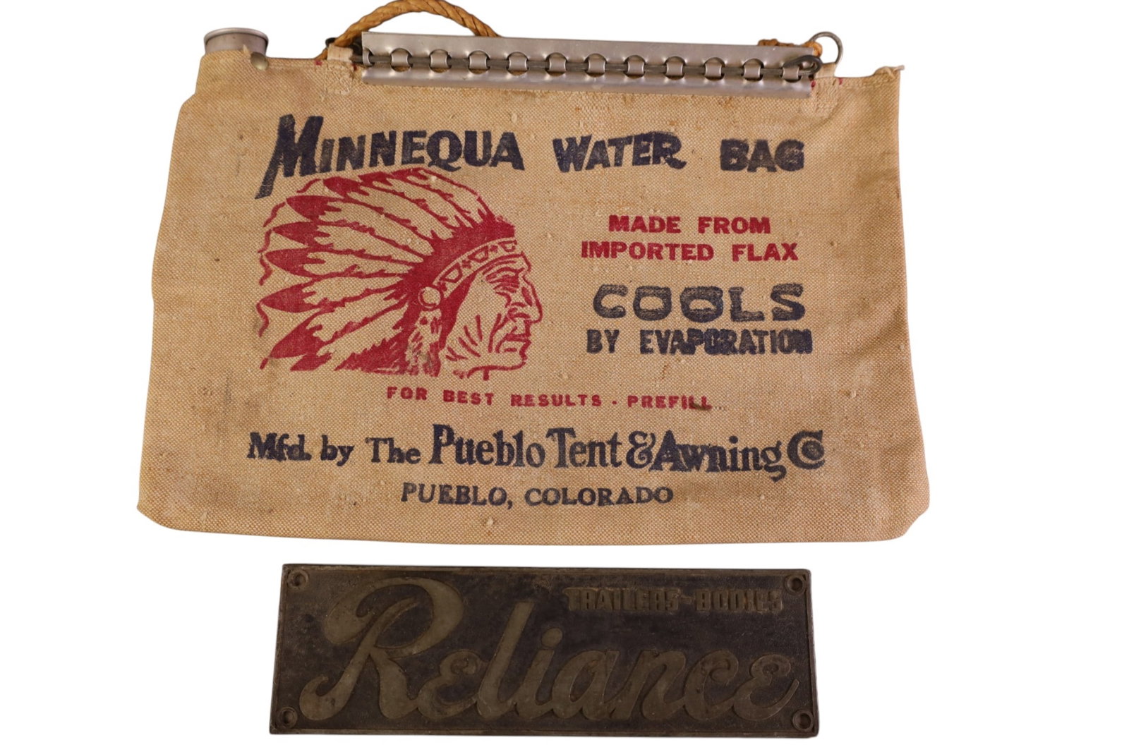 WATER BAG & PLAQUE: VINTAGE MINNEQUA WATER BAG (PUEBLO COLORADO) & RELIANCE TRAILERS AND BODIES PLAQUE. 10" W & 15" W.