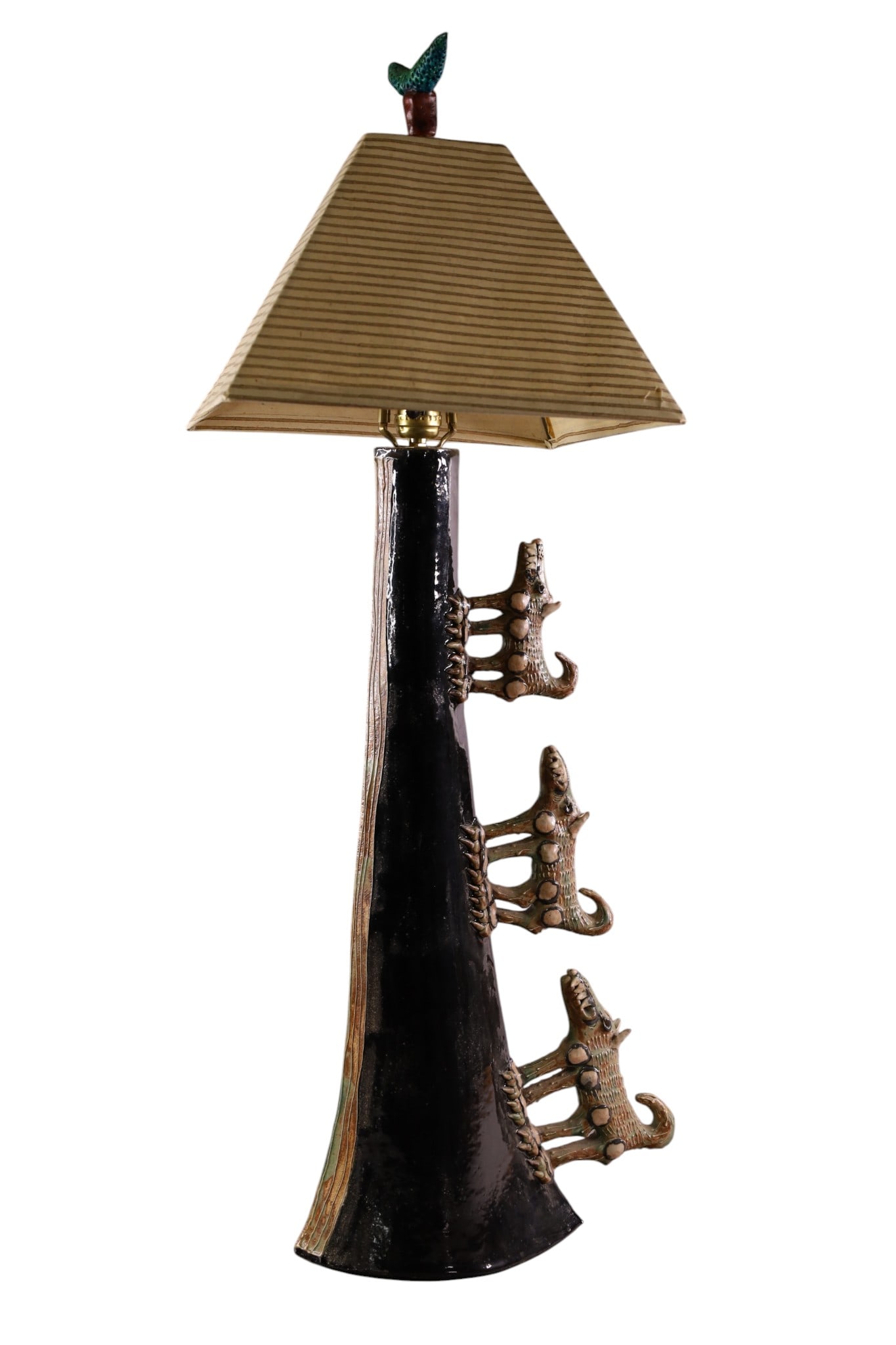 ABSTRACT POTTERY TABLE LAMP: UNUSUAL POTTERY LAMP, WITH ANIMAL DECORATED SIDES. 36" H. THIS ITEM EXCEEDS SIZE LIMITATIONS FOR IN HOUSE SHIPPING, MUST BE PICKED UP IN HOUSE OR SHIPPED VIA 3rd PARTY GROUND SHIPPER.