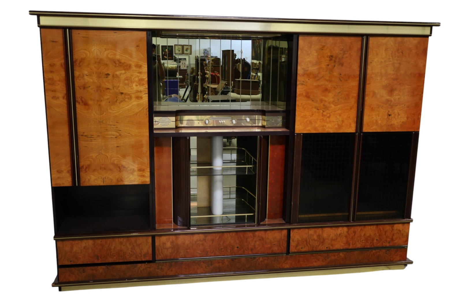 ART DECO STYLE WALL UNIT: LARGE FOUR PART HIGH GLOSS ART DECO STYLE WALL UNIT, CABINET SIDES, LOWER DRAWERS, BAR CABINET CENTER. BRASS TRIM. DAMAGE TO VENEER, CHIPS TO CORNERS. 102" W x 20" D x 73" H. THIS ITEM EXCEEDS SIZE