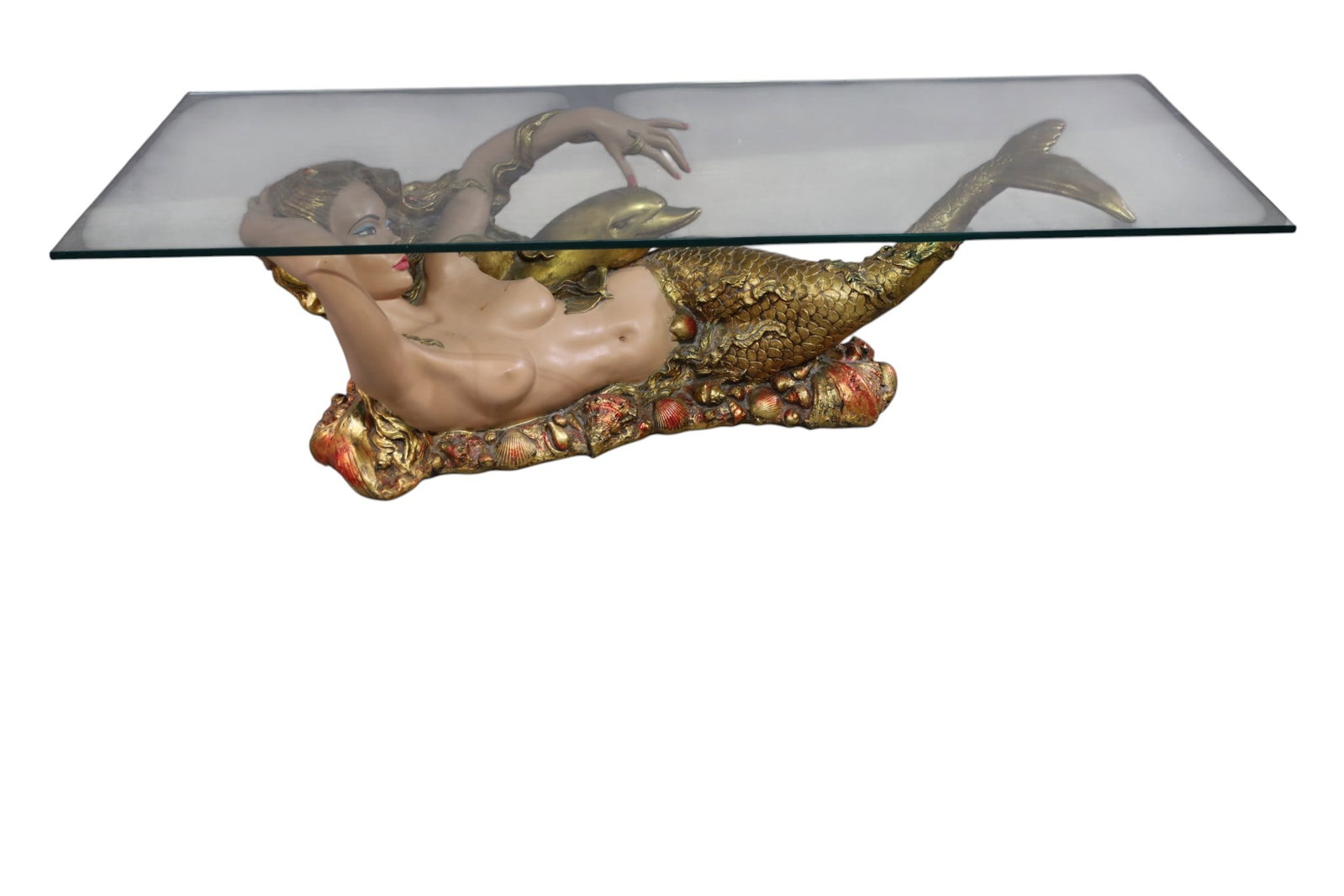 UNUSUAL MERMAID COFFEE TABLE: GLASS TOP COFFEE TABLE, WITH MERMAID AND DOLPHIN PLASTER BASE, SOME CHIPS. 58" L X 24" D x 16" H. THIS ITEM EXCEEDS SIZE LIMITATIONS FOR IN HOUSE SHIPPING, MUST BE PICKED UP IN HOUSE OR SHIPPED VIA