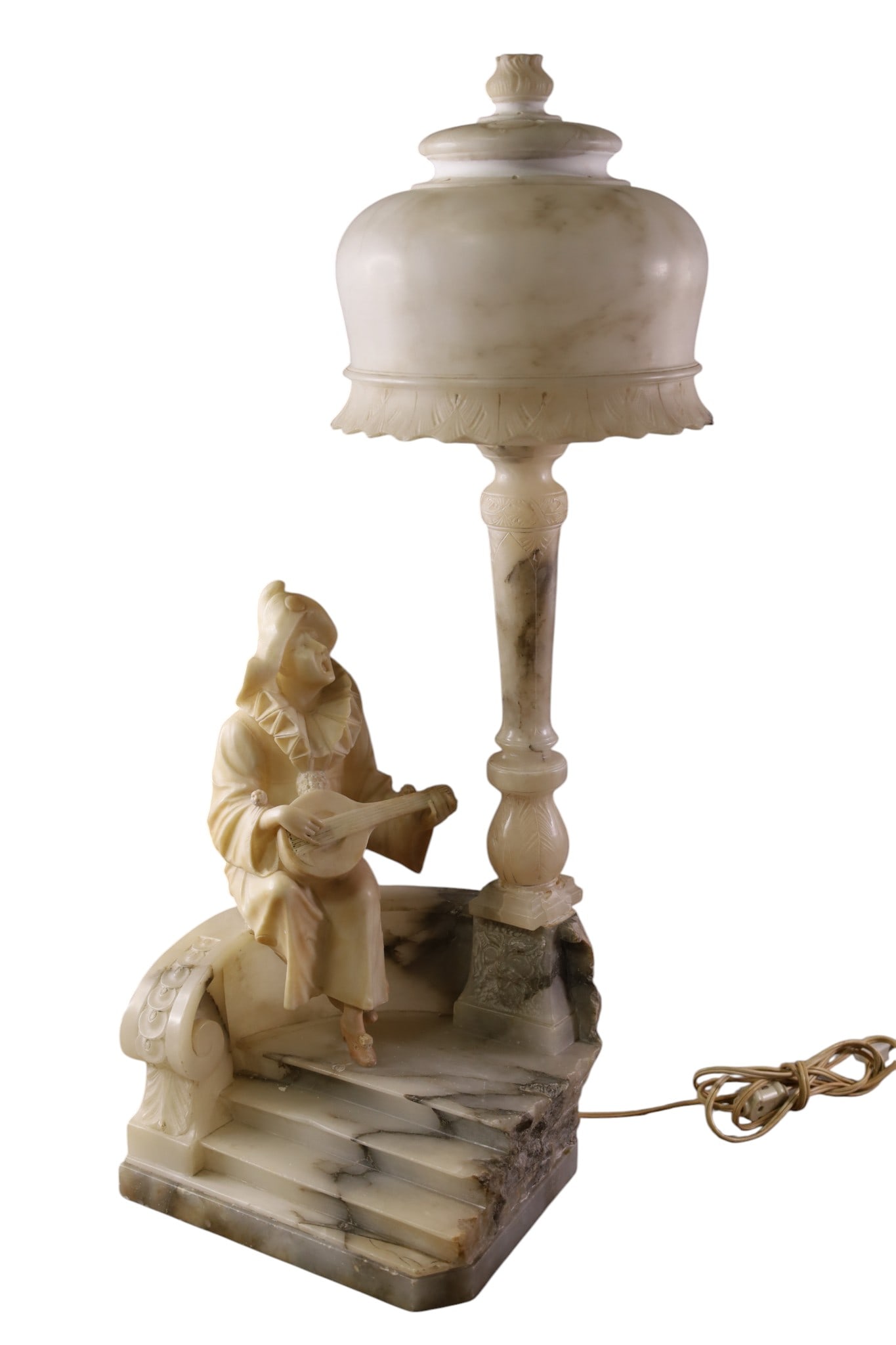 ALABASTER JESTER LAMP: LARGE ALABASTER JESTER LAMP, WITH ALABASTER SHADE, DAMAGE TO STEM, REPAIRS TO SHADE AND CHIPS. 28" H. THIS ITEM EXCEEDS SIZE LIMITATIONS FOR IN HOUSE SHIPPING, MUST BE SHIPPED VIA 3rd PARTY GROUND