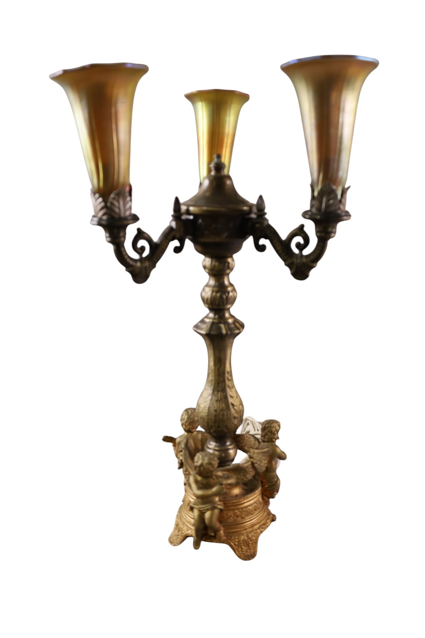 CHERUB LAMP: THREE ARM CHERUB FORM BASE, WITH 3 GOLD AURENE ART GLASS SHADES. 18" H.