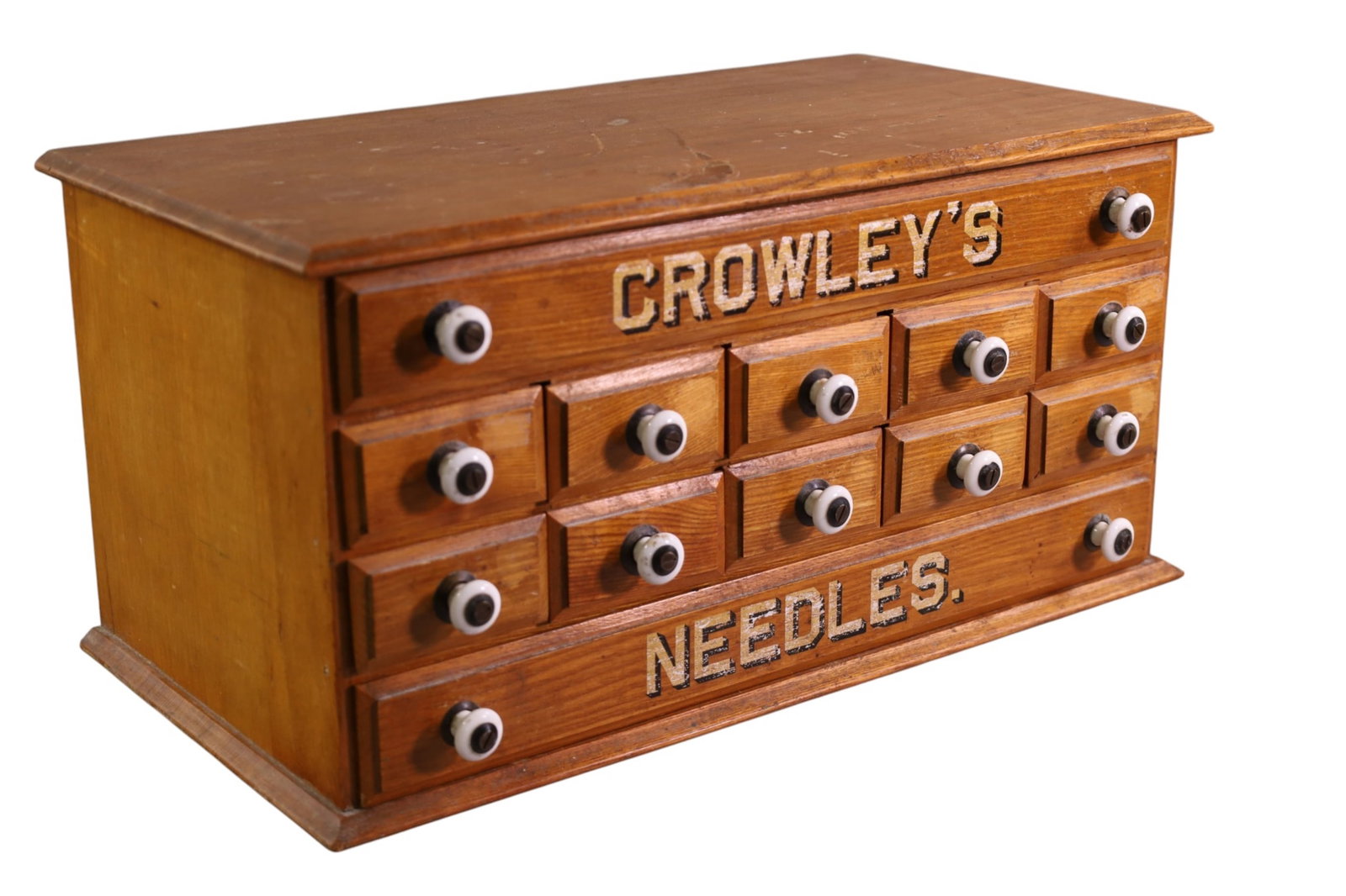CROWLEYS NEEDLE CABINET: TABLE TOP CROWLEYS NEEDLE CABINET WEAR TO FINISH. 19" x 10" D x 9" H. THIS ITEM EXCEEDS SIZE LIMITATIONS FOR IN HOUSE SHIPPING, MUST BE SHIPPED VIA 3rd PARTY GROUND SHIPPER OR PICKED UP IN HOUSE.