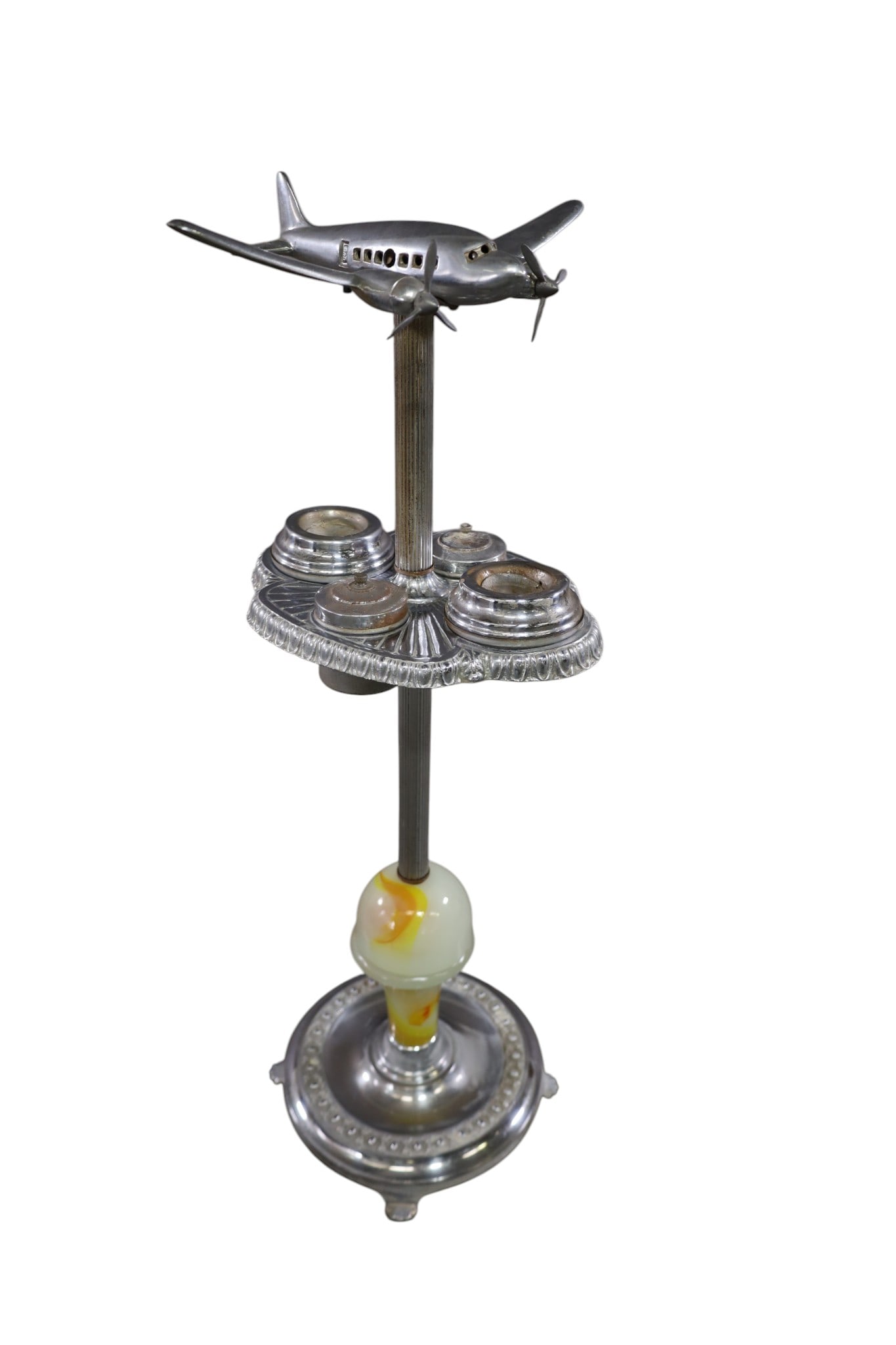 ART DECO AIRPLANE SMOKESTAND: CHROME & AGATE ART DECO SMOKESTAND, AIRPLANE TOP. SOME PITTING & RUST TO SURFACE. 33" H. THIS ITEM EXCEEDS SIZE AND WEIGHT LIMITATIONS FOR IN HOUSE SHIPPING, MUST BE PICKED UP IN HOUSE OR SHIPPED VIA