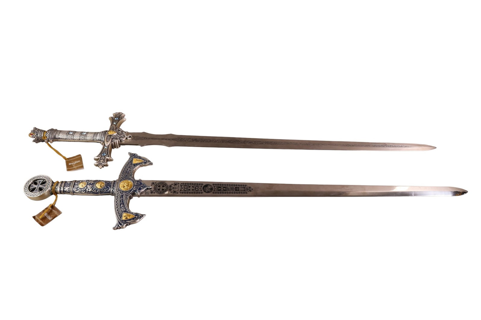 2 DECORATIVE SWORDS: 2 SPANISH DECORATIVE CEREMONIAL SWORDS, ENGRAVED BLADES WITH DECORATIVE HANDLES. 46" & 48" L. THIS ITEM EXCEEDS SIZE AND WEIGHT LIMITATIONS FOR IN HOUSE SHIPPING, MUST BE PICKED UP IN HOUSE OR