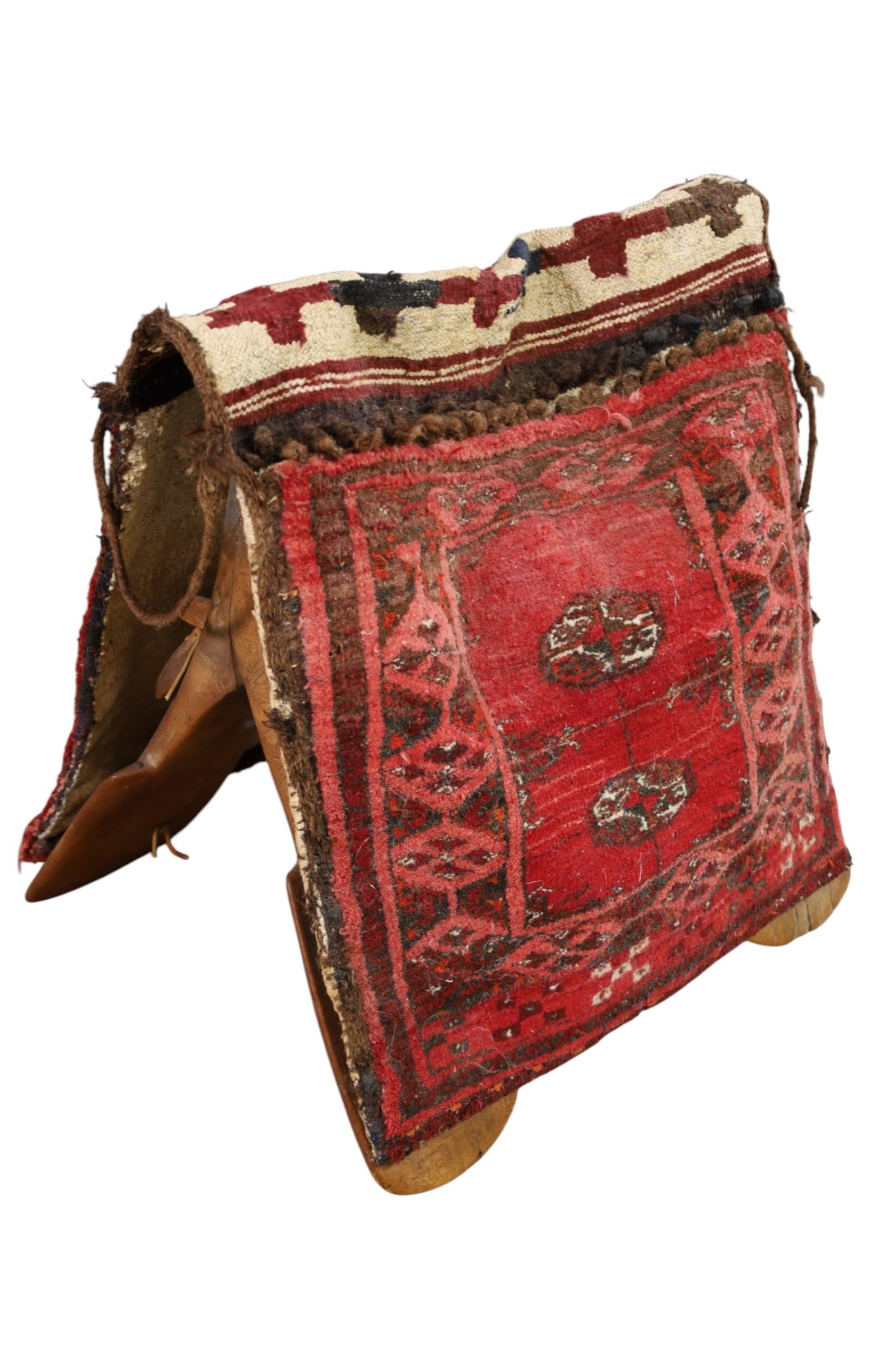 SADDLE BAG ON SADDLE: ANTIQUE HANDWOVEN SADDLE BAG ON SADDLE STAND. 24" L x 23" H. THIS ITEM EXCEEDS SIZE AND WEIGHT LIMITATIONS FOR IN HOUSE SHIPPING, MUST BE PICKED UP IN HOUSE OR SHIPPED VIA 3rd PARTY GROUND SHIPPER.