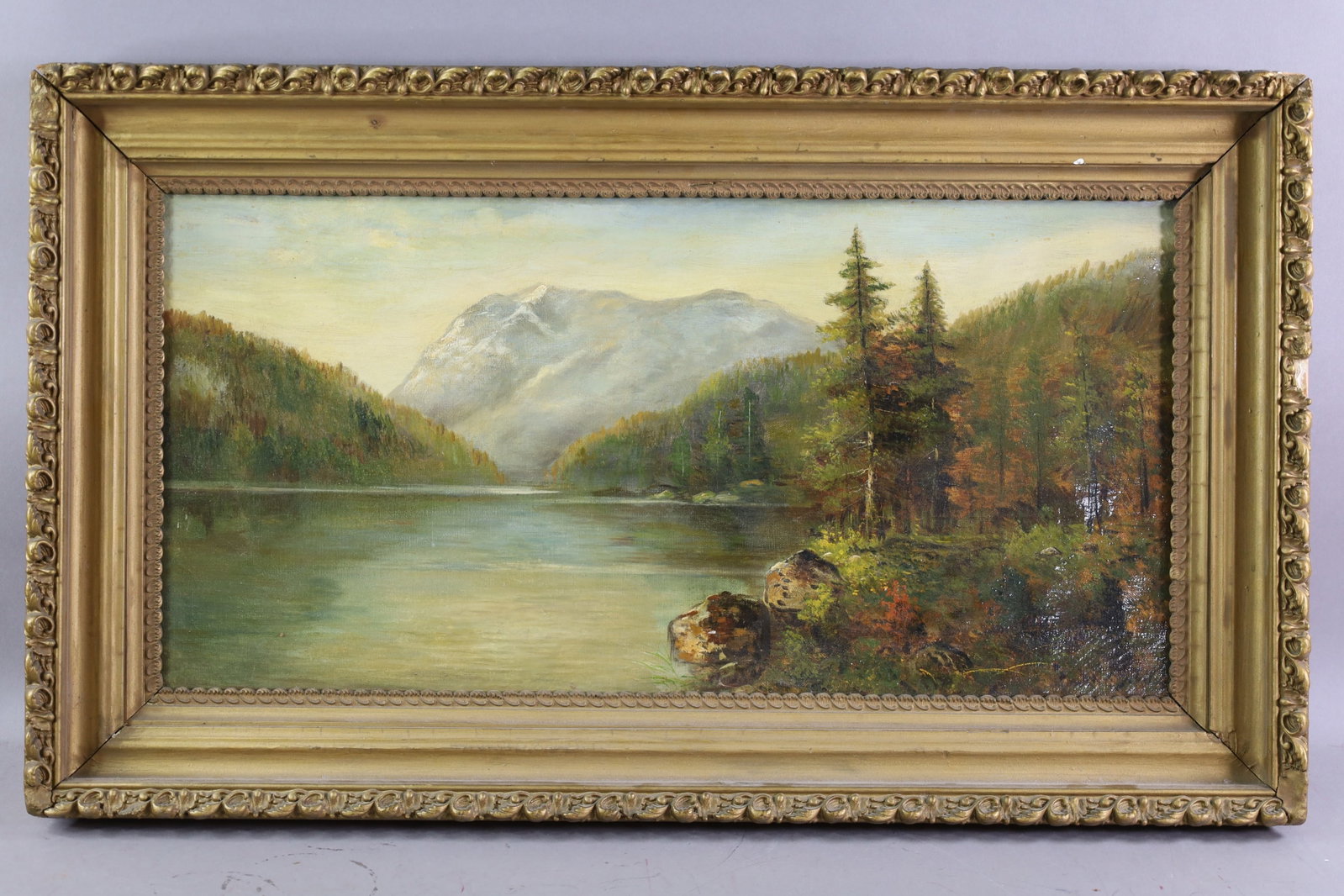 JOHN STOLL OIL PAINTING: OIL ON CANVAS, SIGNED LOWER RIGHT, MOUNTAIN LANDSCAPE OIL PAINTING. 25" x 12 1/2" IMAGE SIZE / 30" x 17 1/2" IN FRAME. THE WORK IS OFFERED FROM A PRIVATE COLLECTION AND IS UNACCOMPANIED BY