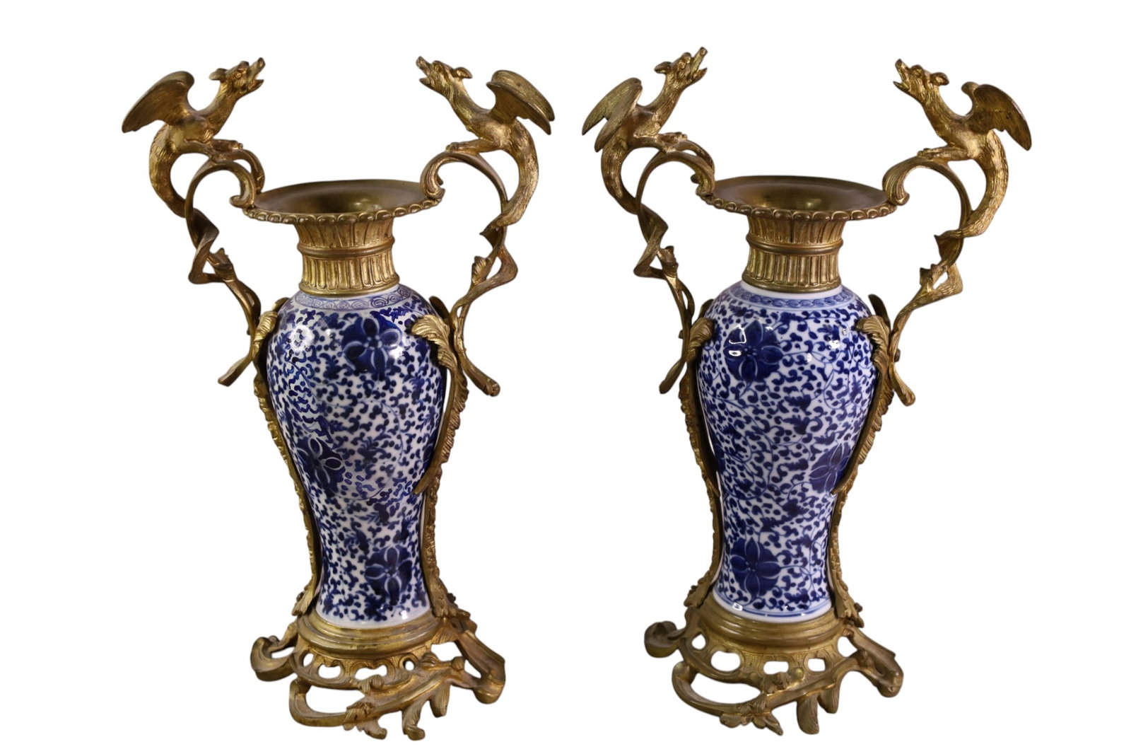 PORCELAIN AND BRONZE MANTLE VASES: PAIR 18th C CHINESE BLUE AND WHITE PORCELAIN VASES, IN DORE BRONZE MOUNTS WITH DRAGON DECORATION. ONE VASE HAS BEEN REPAIRED. 8 1/2" W x 13 1/2" H.
