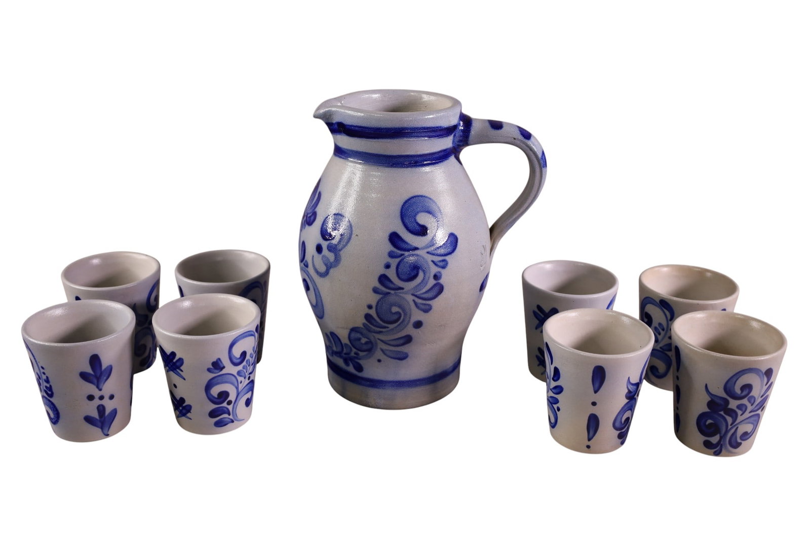 GERMAN SALTGLAZED DRINKSET: SALTGLAZED STONEWARE COBALT DECORATED, PITCHER AND 8 CUPS. 3 3/4" H CUPS & 9" H PITCHER.