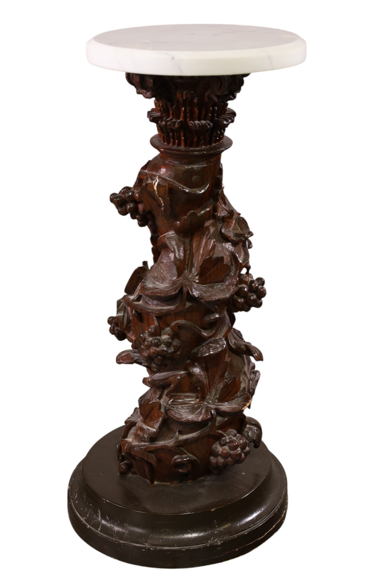 CARVED WOOD PEDESTAL: MARBLE TOP, HIGHLY CARVED WOOD BASE, GRAPE VINE DECORATED. 12 1/2" DIAM x 32" H. THIS ITEM EXCEEDS SIZE AND WEIGHT LIMITATIONS FOR IN HOUSE SHIPPING, MUST BE PICKED UP IN HOUSE OR SHIPPED VIA 3rd PART