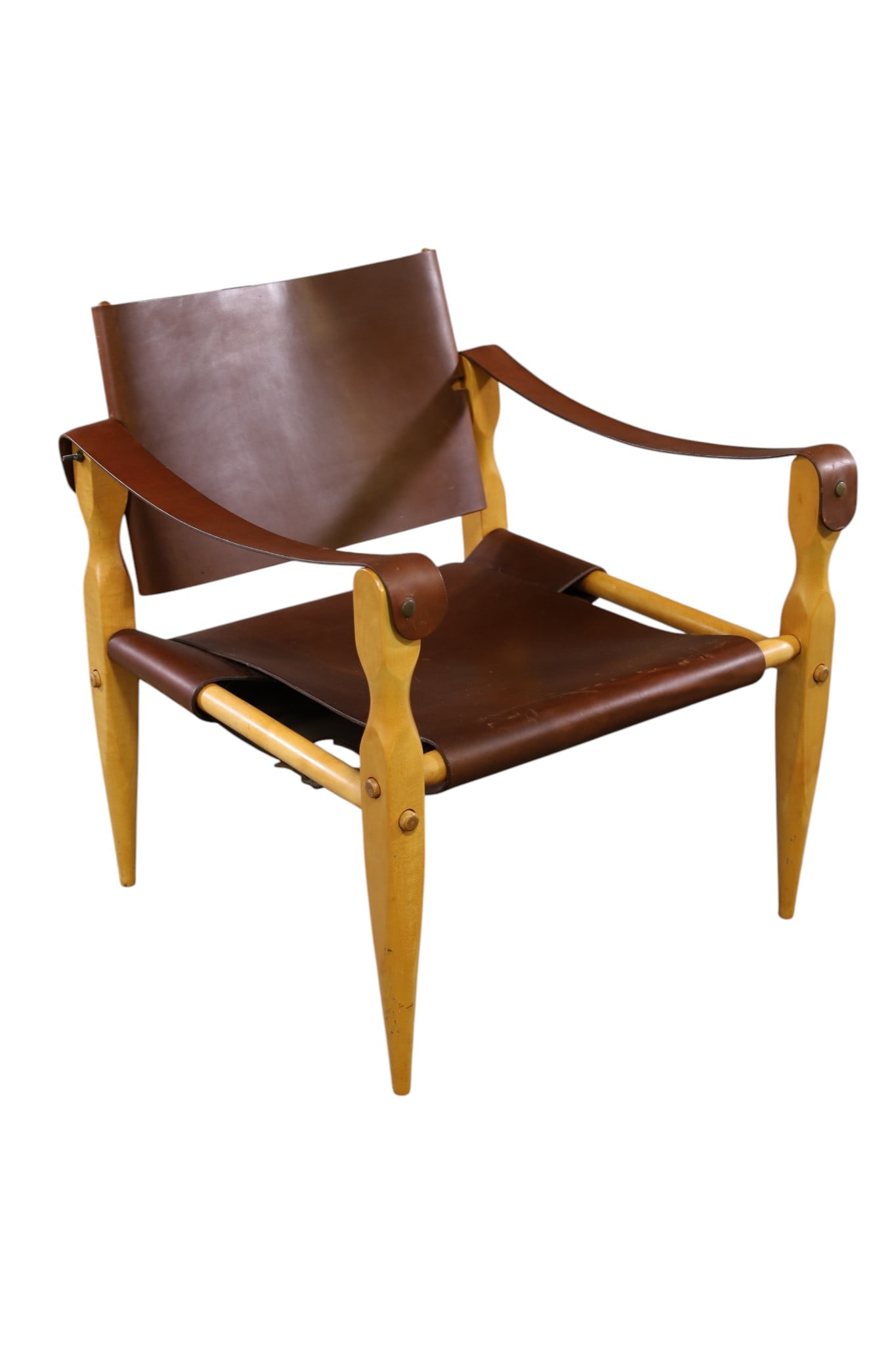 MCM SAFARI CHAIR: MID CENTURY MODERN BROWN LEATHER AND WOOD FRAME SAFARI CHAIR, ATTRIBUTED TO WILHELM KIENZLE, 24" W x 24" D x 27" H. THIS ITEM EXCEEDS SIZE, WEIGHT, AND OR FRAGILITY LIMITATIONS FOR IN HOUSE SHIPPING,