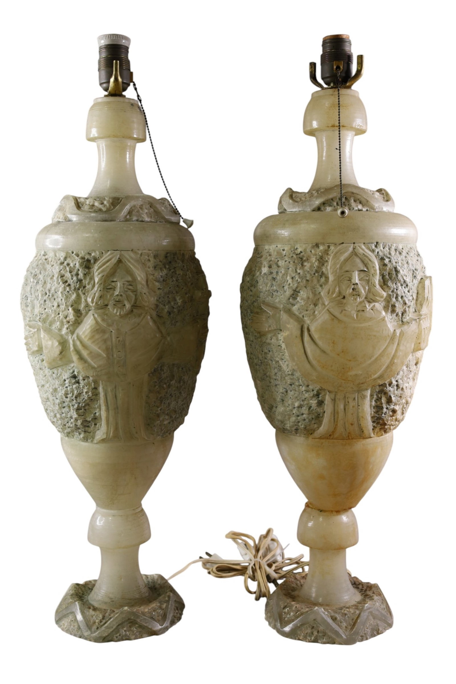 PAIR OF CARVED STONE LAMPS: PAIR OF CARVED STONE LAMPS, SOME CHIPS. (RELIGIOUS THEME) 27" H. THIS ITEM EXCEEDS SIZE, WEIGHT, AND OR FRAGILITY LIMITATIONS FOR IN HOUSE SHIPPING, MUST BE PICKED UP IN HOUSE OR SHIPPED VIA 3rd