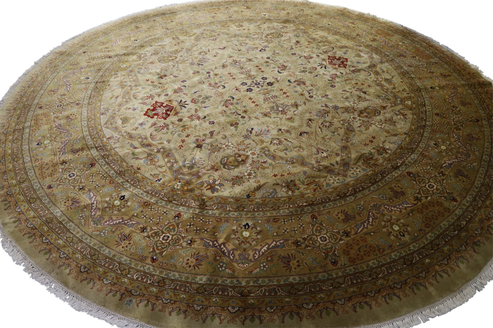 APPROX 11' 8" HANDMADE WOOL RUG: LARGE ROUND HANDMADE WOOL RUG. THIS ITEM EXCEEDS SIZE, WEIGHT, AND OR FRAGILITY LIMITATIONS FOR IN HOUSE SHIPPING, MUST BE PICKED UP IN HOUSE OR SHIPPED VIA 3rd PARTY GROUND SHIPPER.