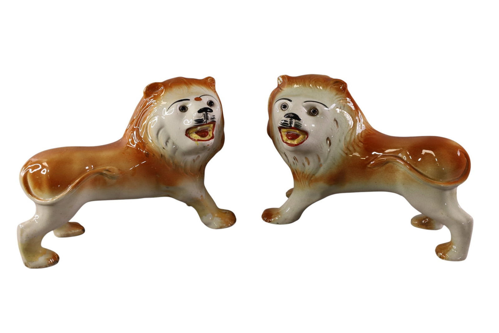 PAIR OF STAFFORDSHIRE LIONS: PAIR OF ANTIQUE STAFFORDSHIRE LIONS, , GLASS EYES. UNMARKED. 14" L. x 9 1/2" H.