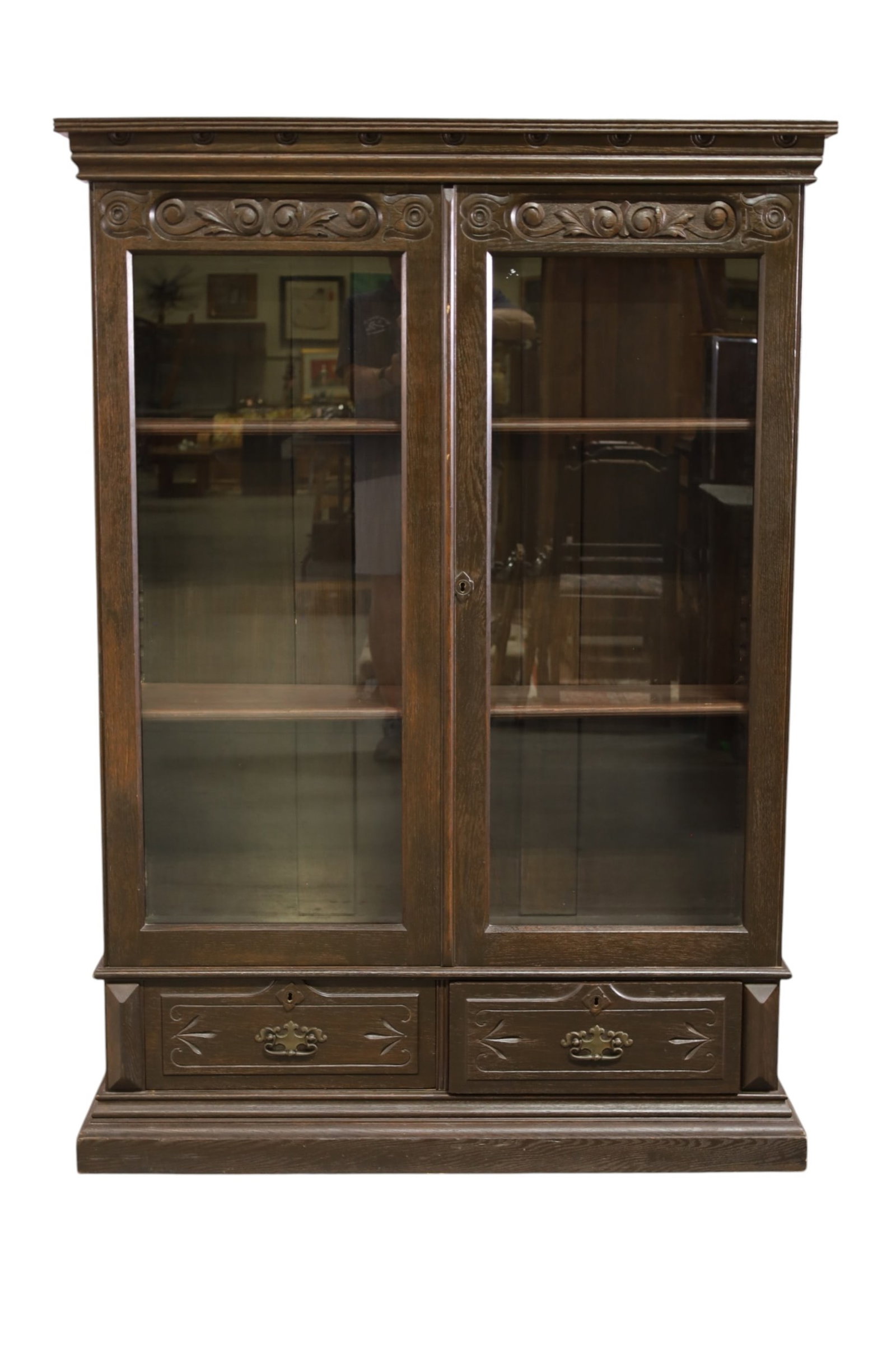 VICTORIAN BOOKCASE: LARGE VICTORIAN TWO DOOR BOOKCASE, TWO LOWER DRAWERS. WEAR TO FINISH. 44" W x 19" D x 62" H. THIS ITEM EXCEEDS SIZE, WEIGHT, AND OR FRAGILITY LIMITATIONS FOR IN HOUSE SHIPPING, MUST BE PICKED UP IN