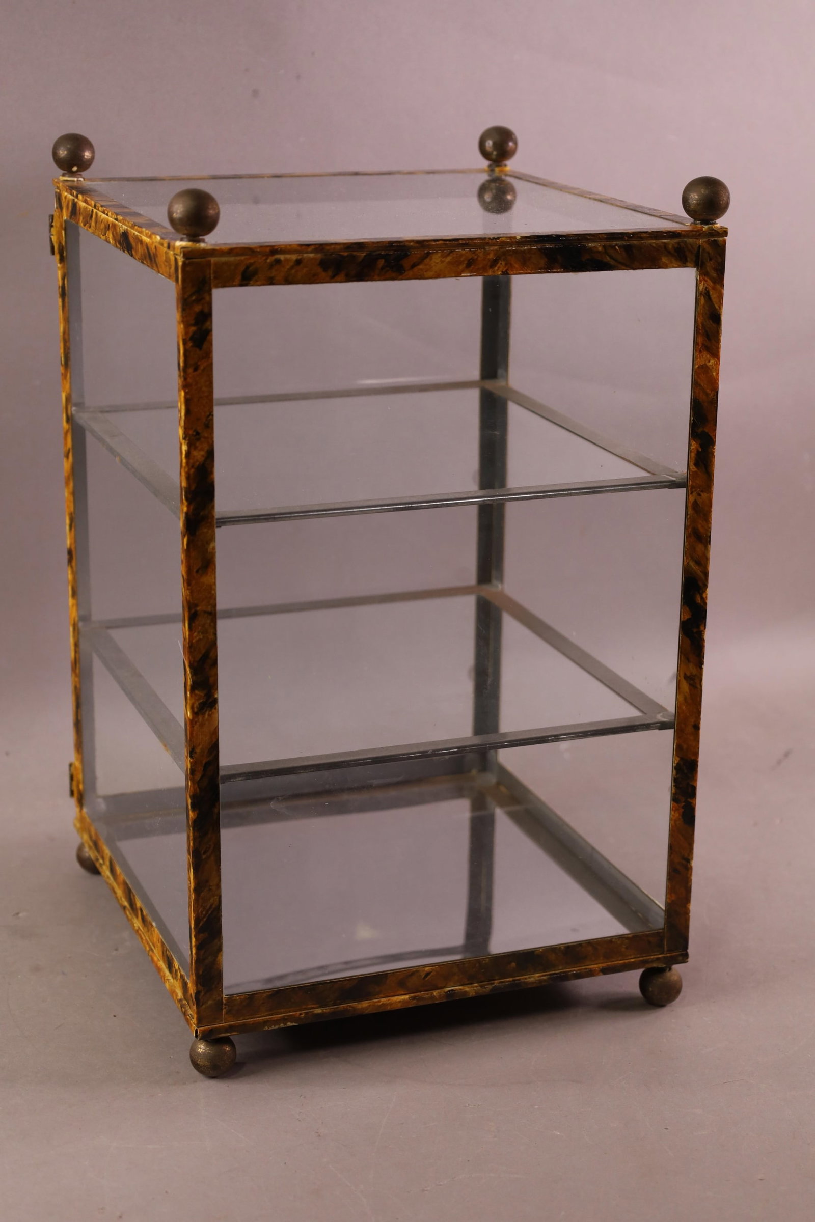 ANTIQUE TABLE TOP DISPLAY CABINET: METAL WITH FAUX GRAIN, INTERIOR SHELVES. 10" W x 10 1/2" x 15 1/2" H.