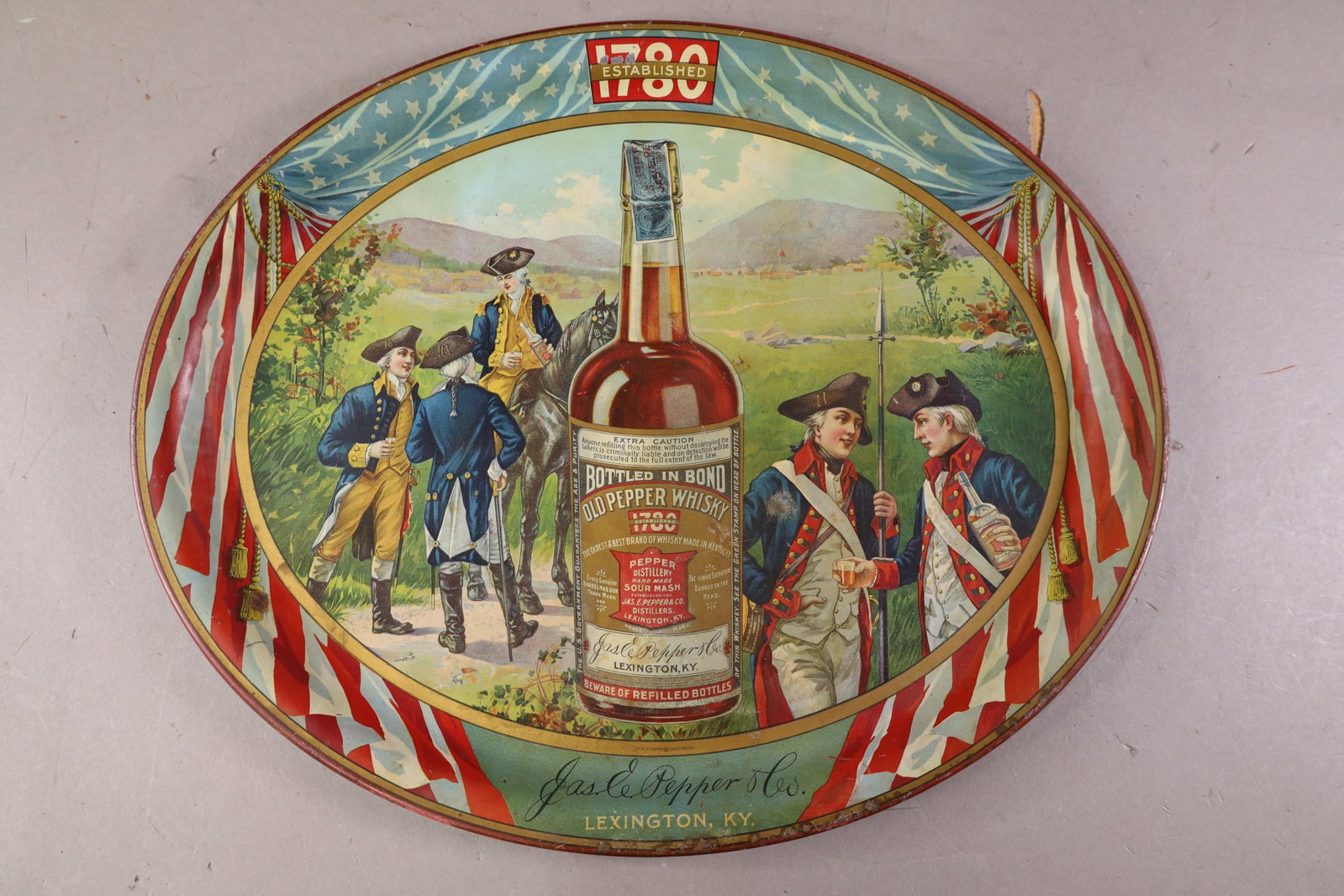 OLD PEPPER WHISKY TRAY: LARGE TRAY, SCRATCHES, PAINT LOSS. 16 1/2" DIAM