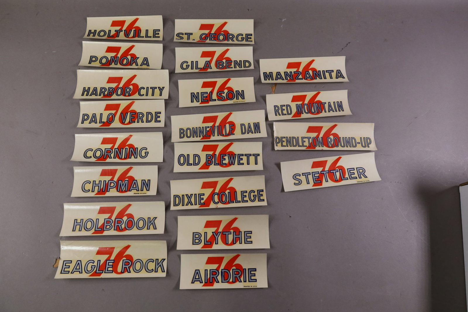 20 UNION 76 WATER TRANSFER DECALS: INCLUDING, RED MOUNTAIN, EAGLE ROCK, HOLBROOK AND MORE. EDGES ARE CURLED.