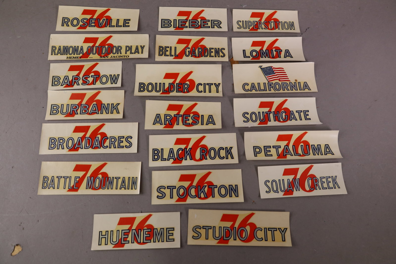 20 UNION 76 WATER TRANSFER DECALS: INCLUDING, BARSTOW, BATTLE MOUNTAIN, BELL GARDENS. AND MORE. EDGES ARE CURLED.