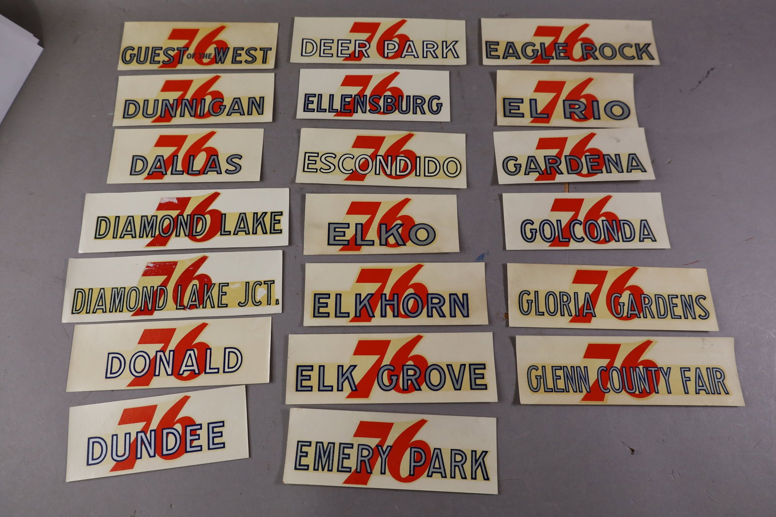 20 UNION 76 WATER TRANSFER DECALS: INCLUDING, DALLAS, ELKHORN, AND MORE. EDGES ARE CURLED.
