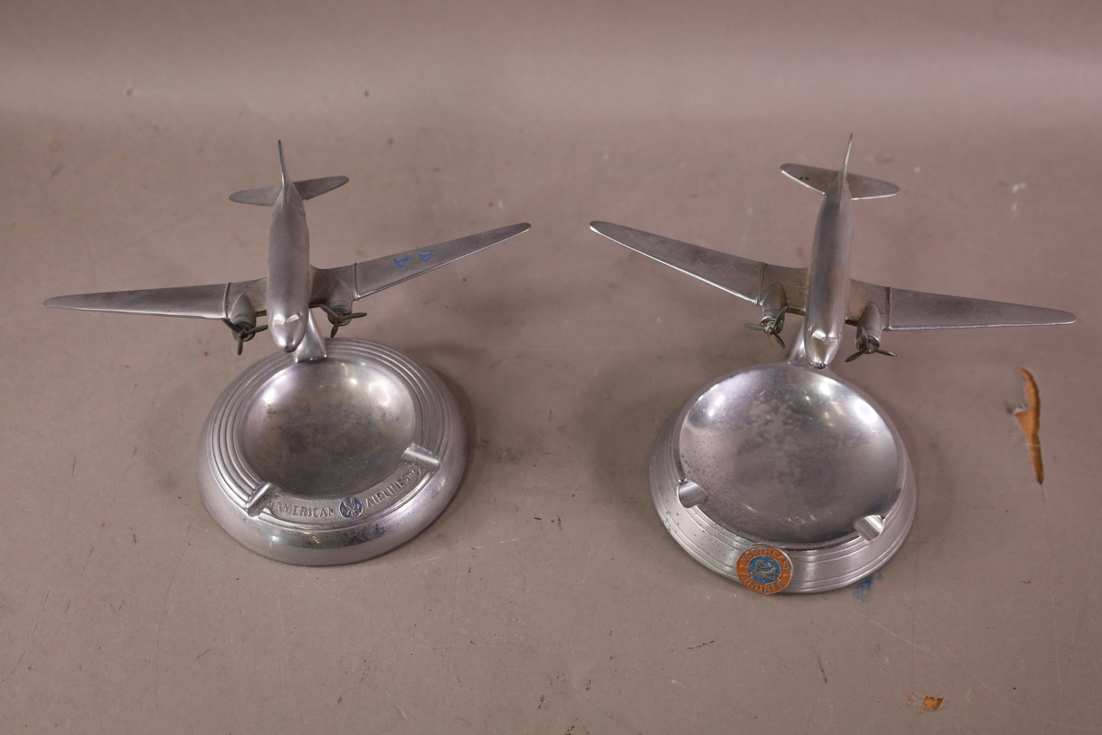 2 VINTAGE AIRLINE MODEL ASHTRAYS: NORTHEAST AIRLINES, AMERICAN AIRLAINES MODEL ASHTRAYS. BY AIRTRAY. 8" W.