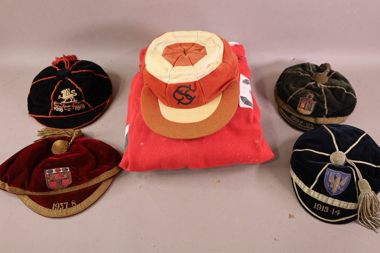 ANTIQUE RUGBY & CRICKET HATS & JERSEYS: GROUPING OF ANTIQUE JERSEYS AND HATS, 1902, 1913, 1918, AND MORE